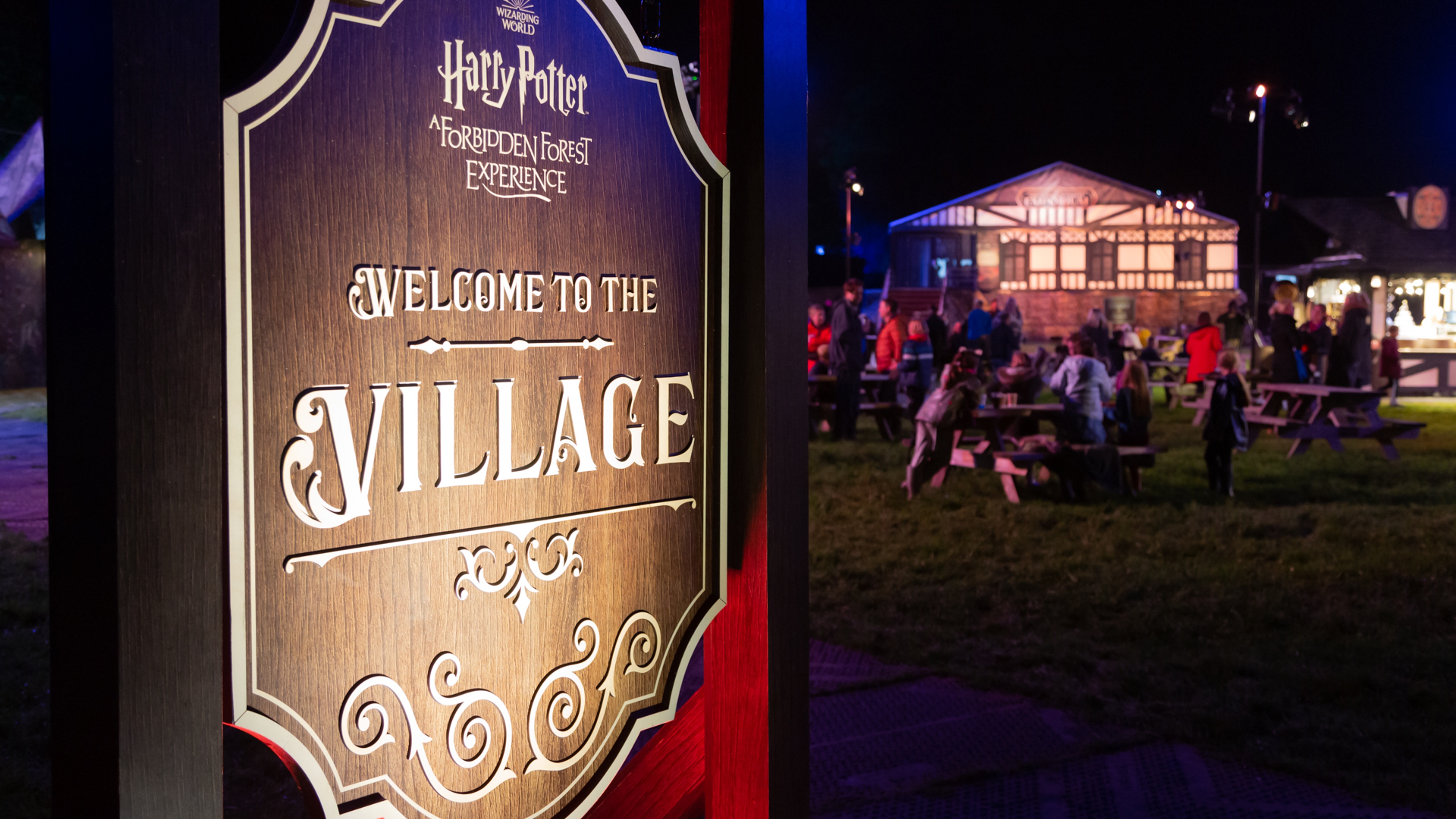 Harry Potter: A Forbidden Forest Experience wayfinding signage that says Welcome To The Village