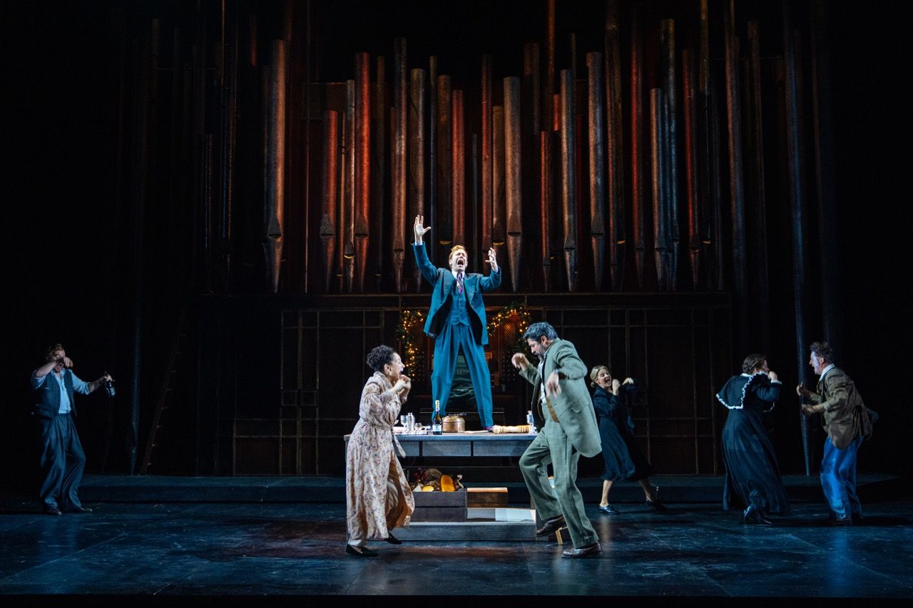 Ensemble of performers dancing on stage