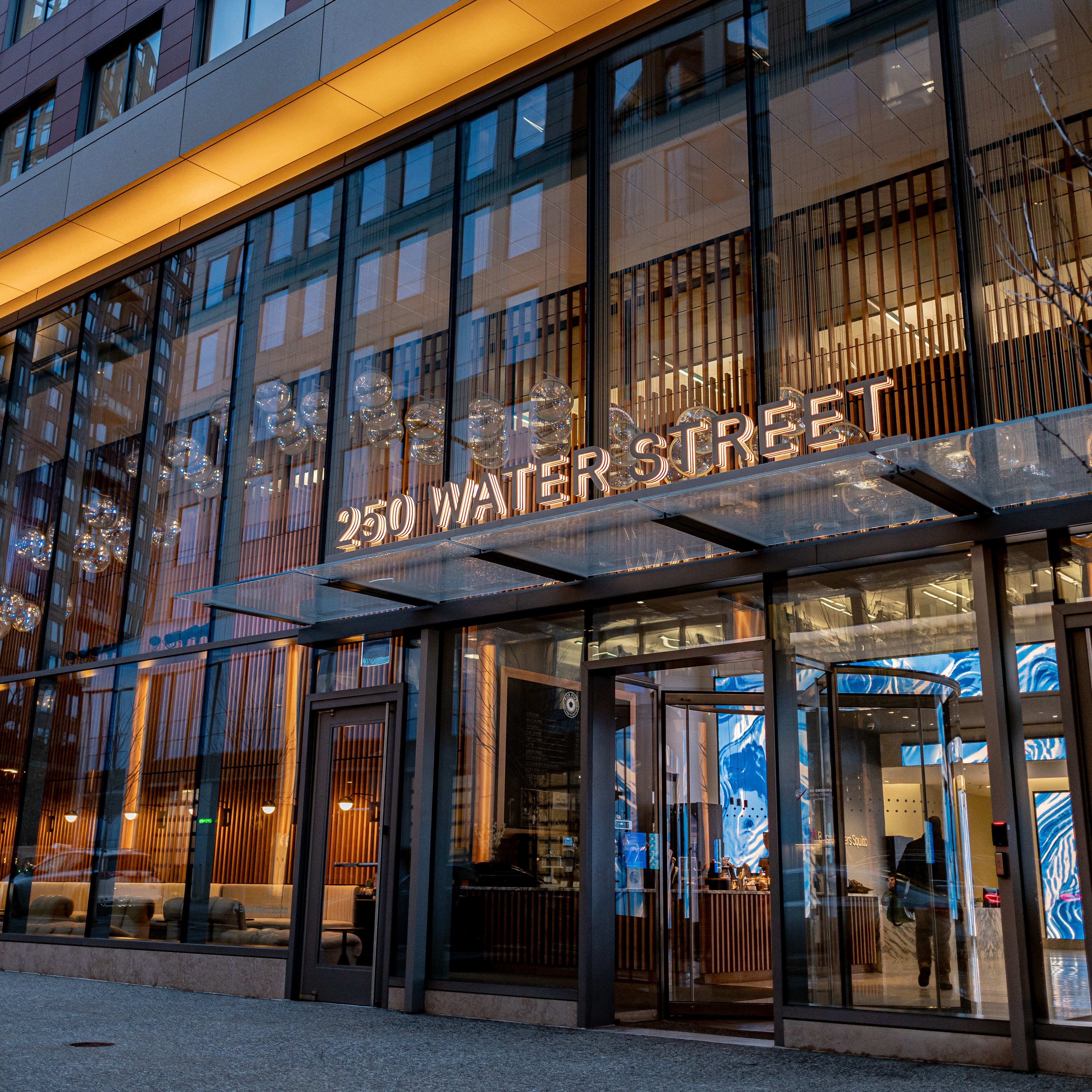 Exterior shot of Bristol Myers Squibb building with warm yellow accent lighting