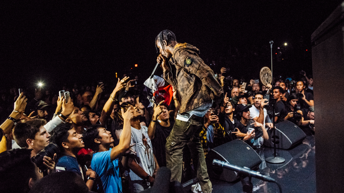 image of audience in front of Nike uniform display and 3 large vertical screens
