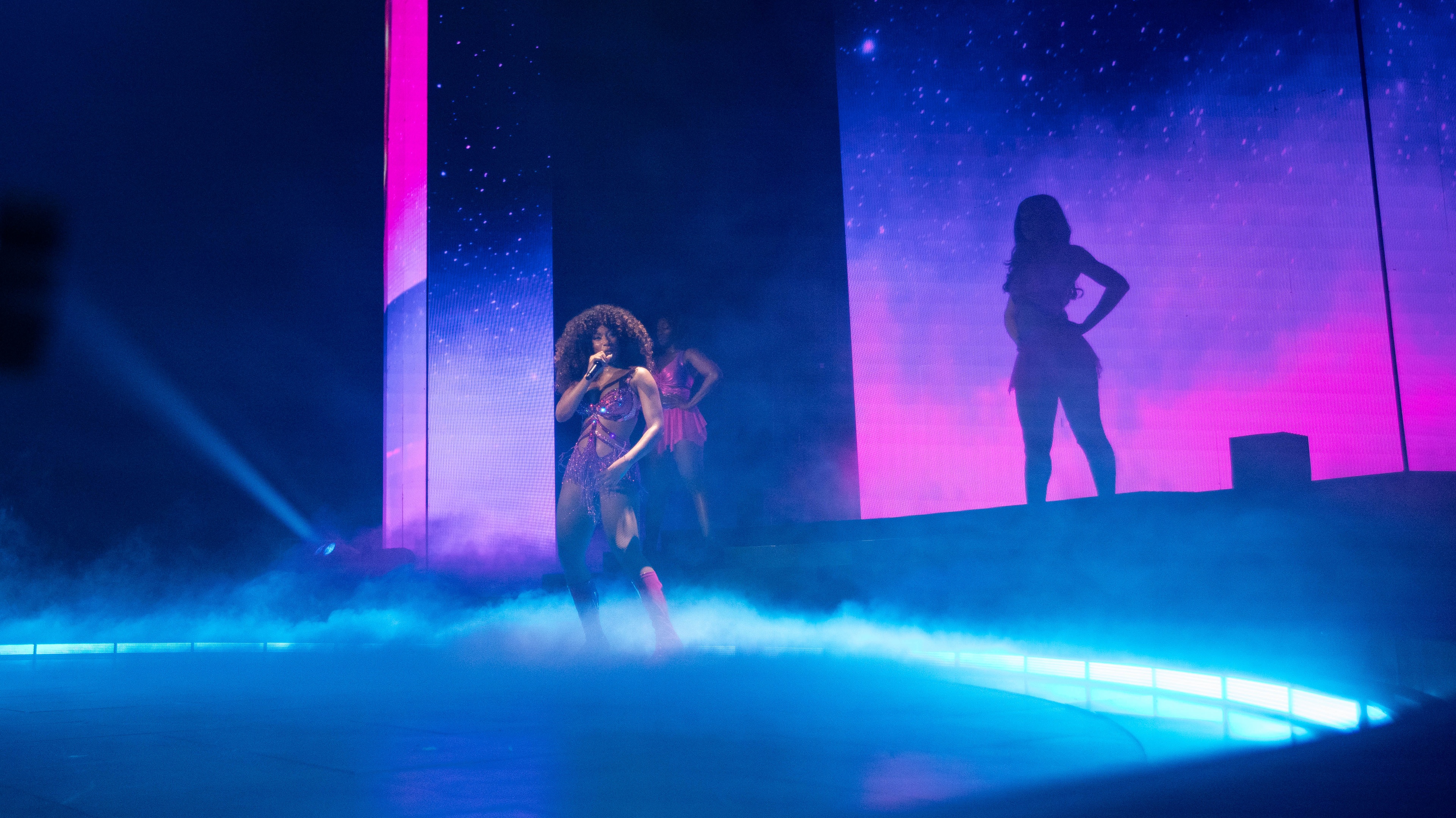 Megan Thee Stallion on stage with fog and blue lighting