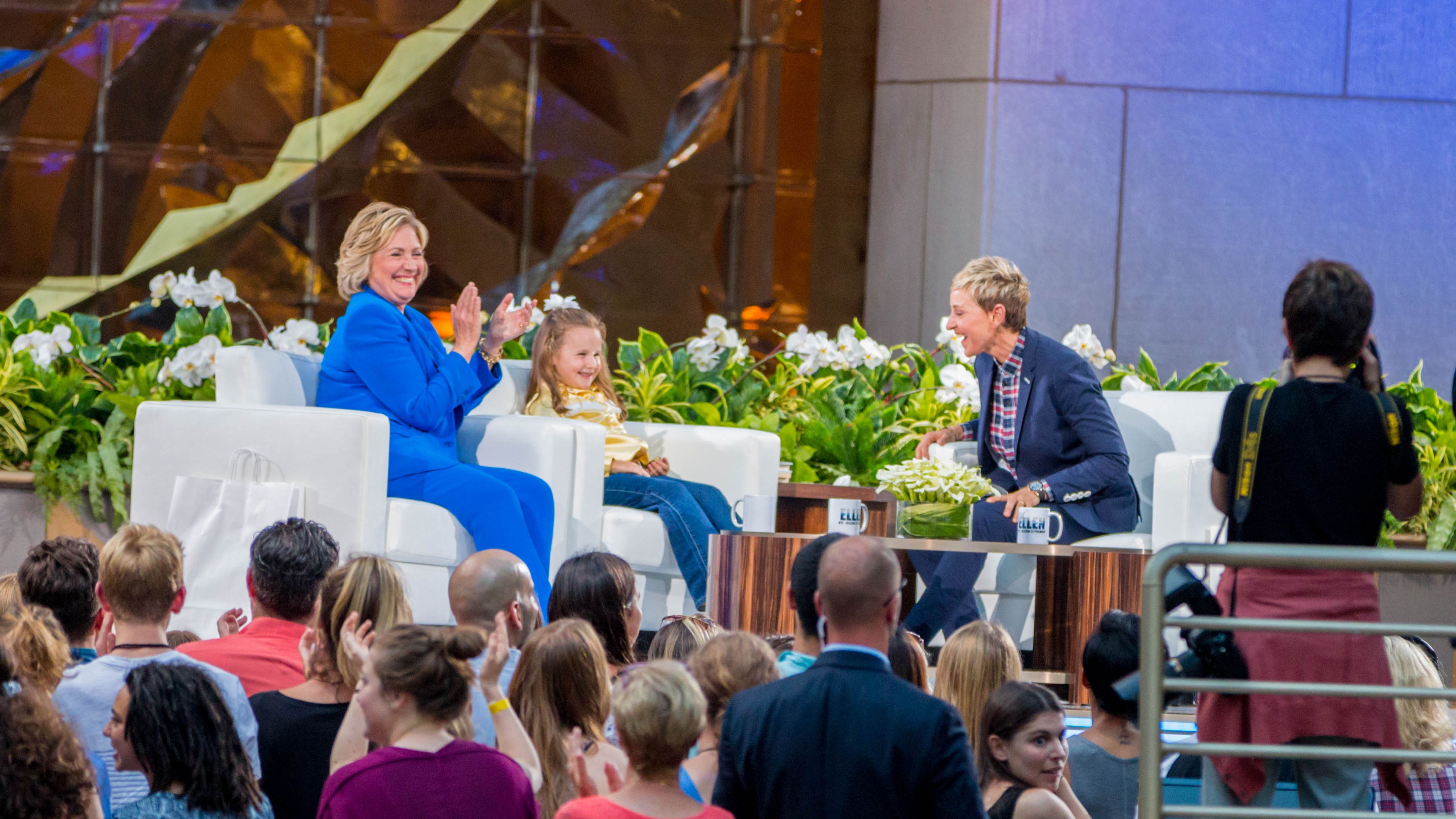 Ellen DeGeneres on stage with guests looking excited