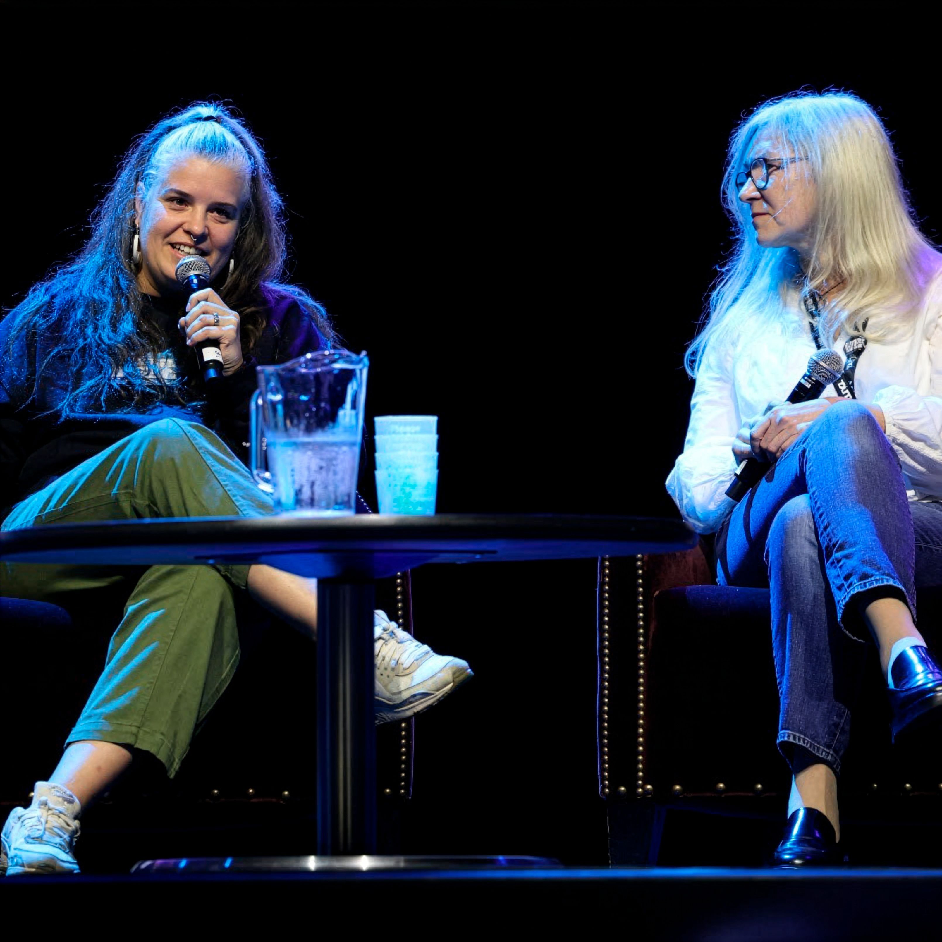 2 industry professionals sat on stage at a panel