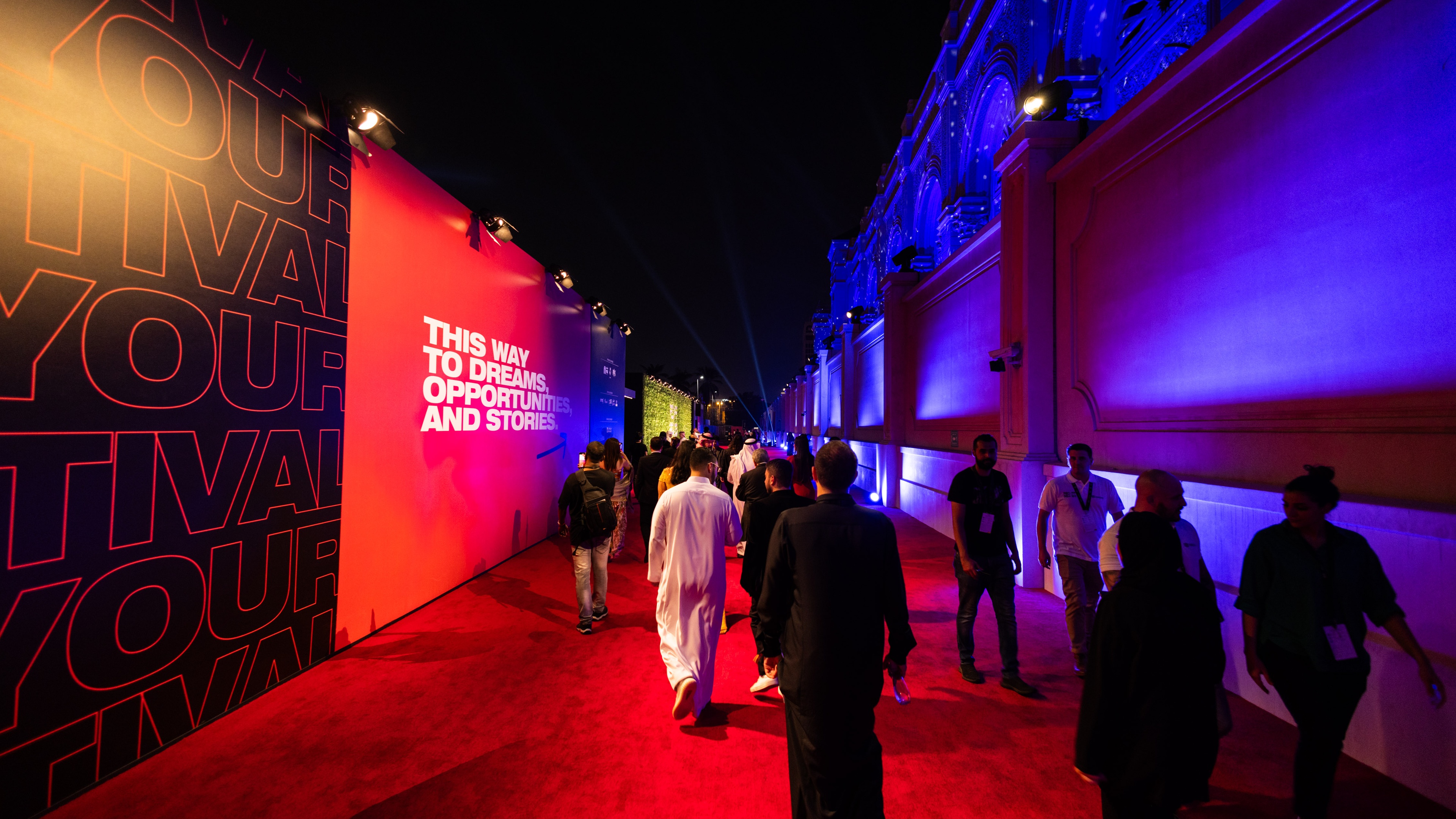 Attendees of Red Sea International Film Festival walking down red carpet