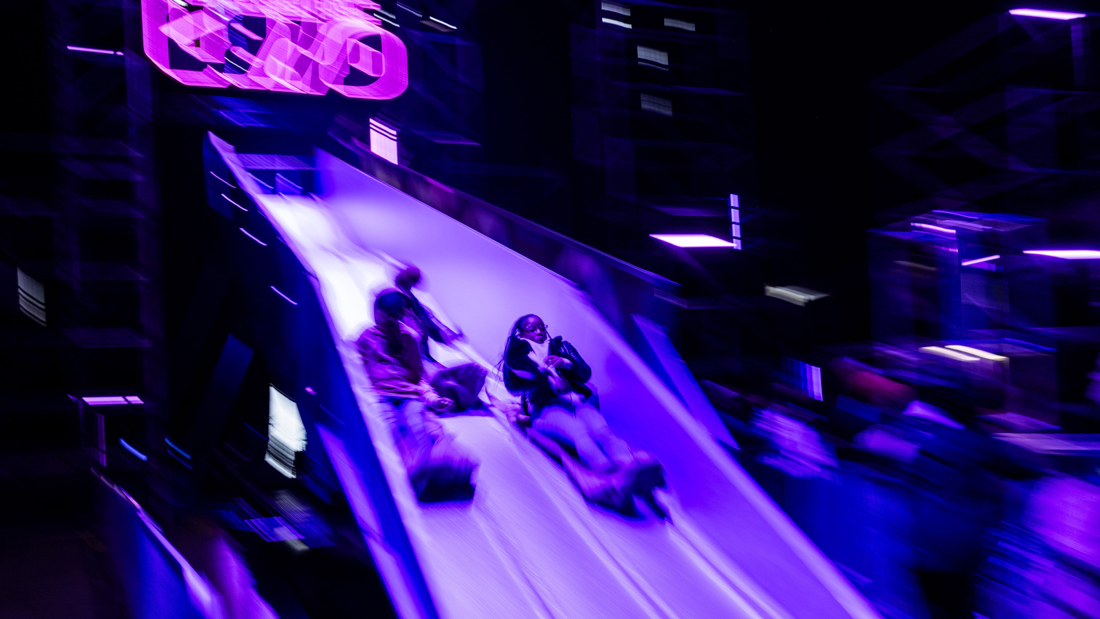 Attendees sliding down slide