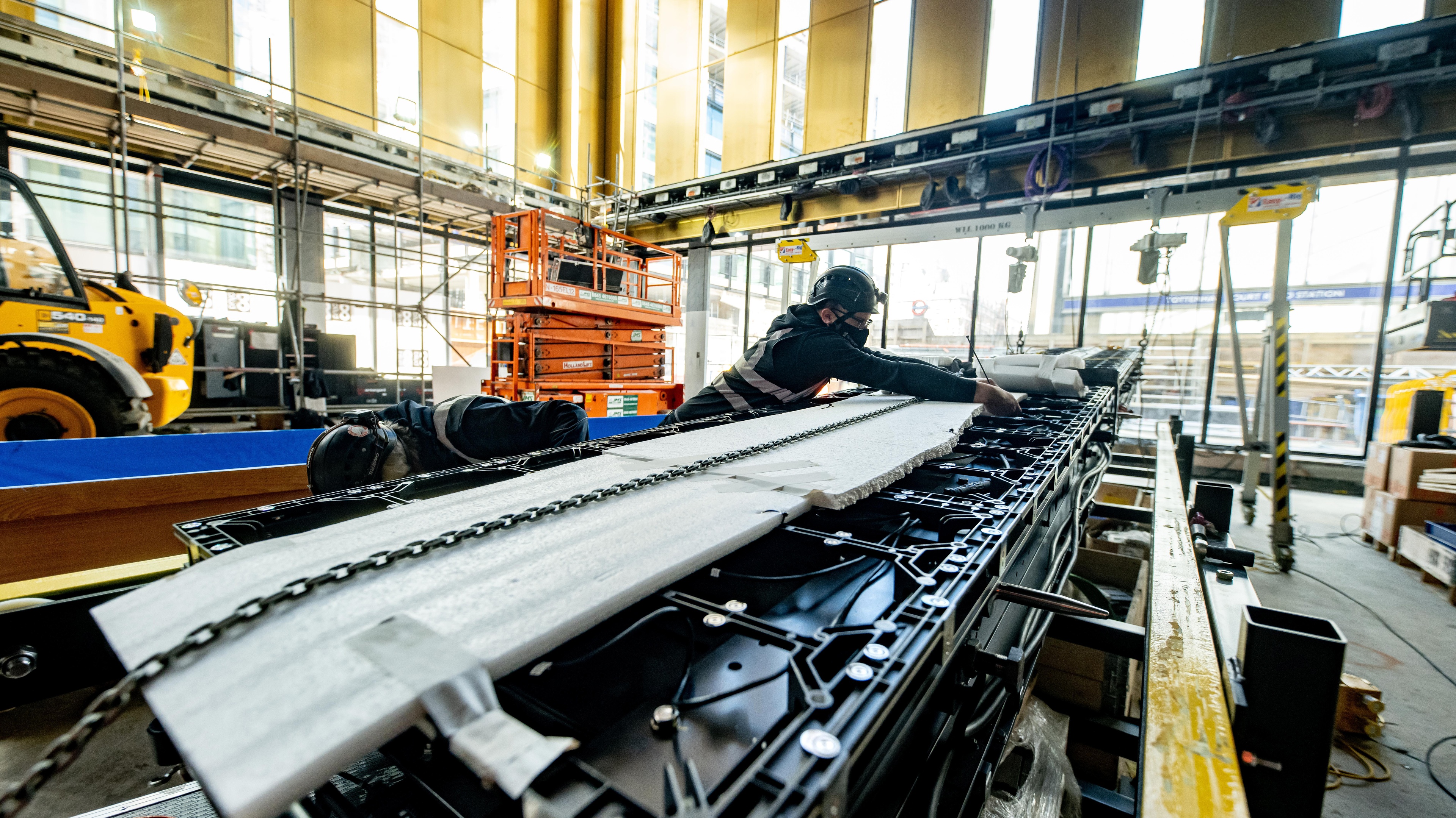 Person working on integrating steel structure wearing hard helmet