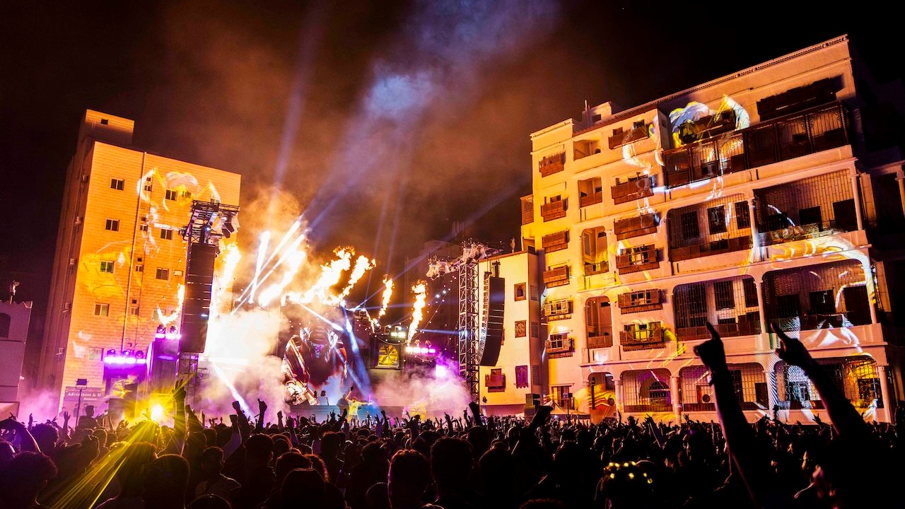 Outdoor stage with pyro in Al-Balad, crowd is in the foreground