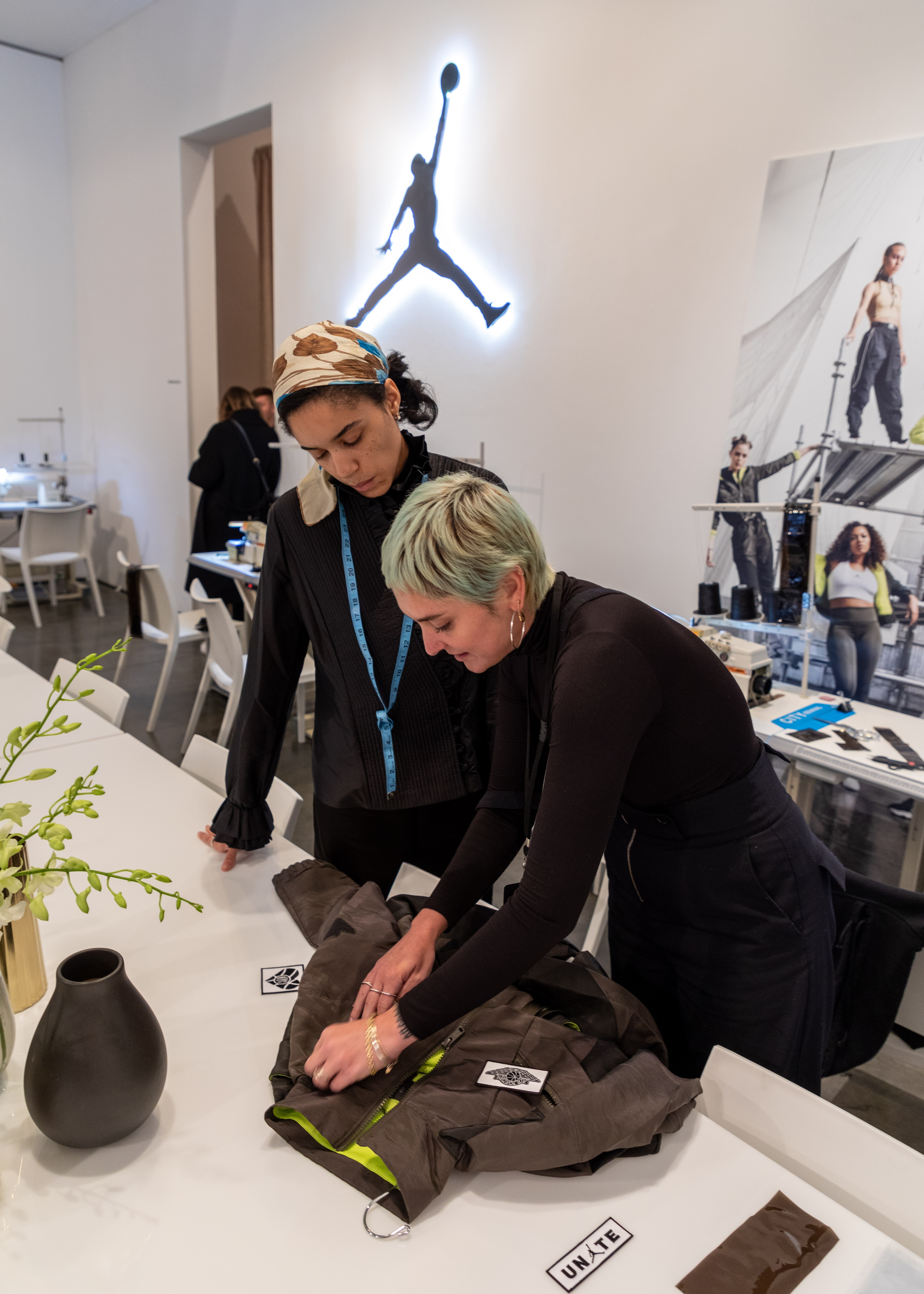 Two women zipping up jacket