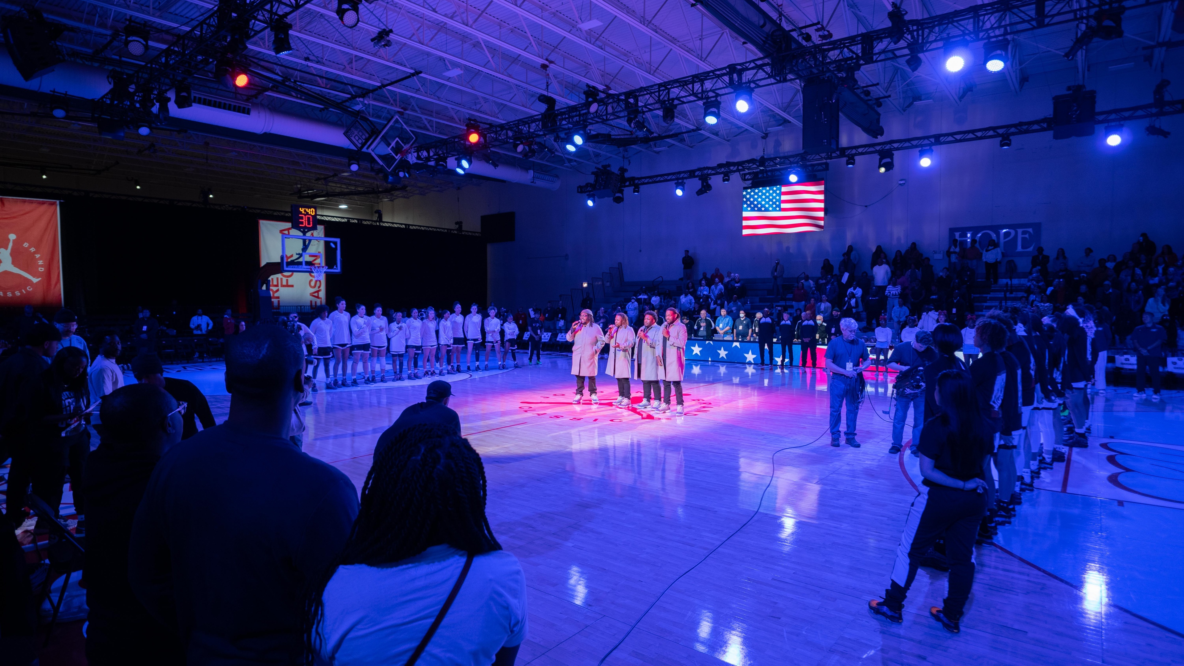 Basketball court lit up blue with players posing on the court