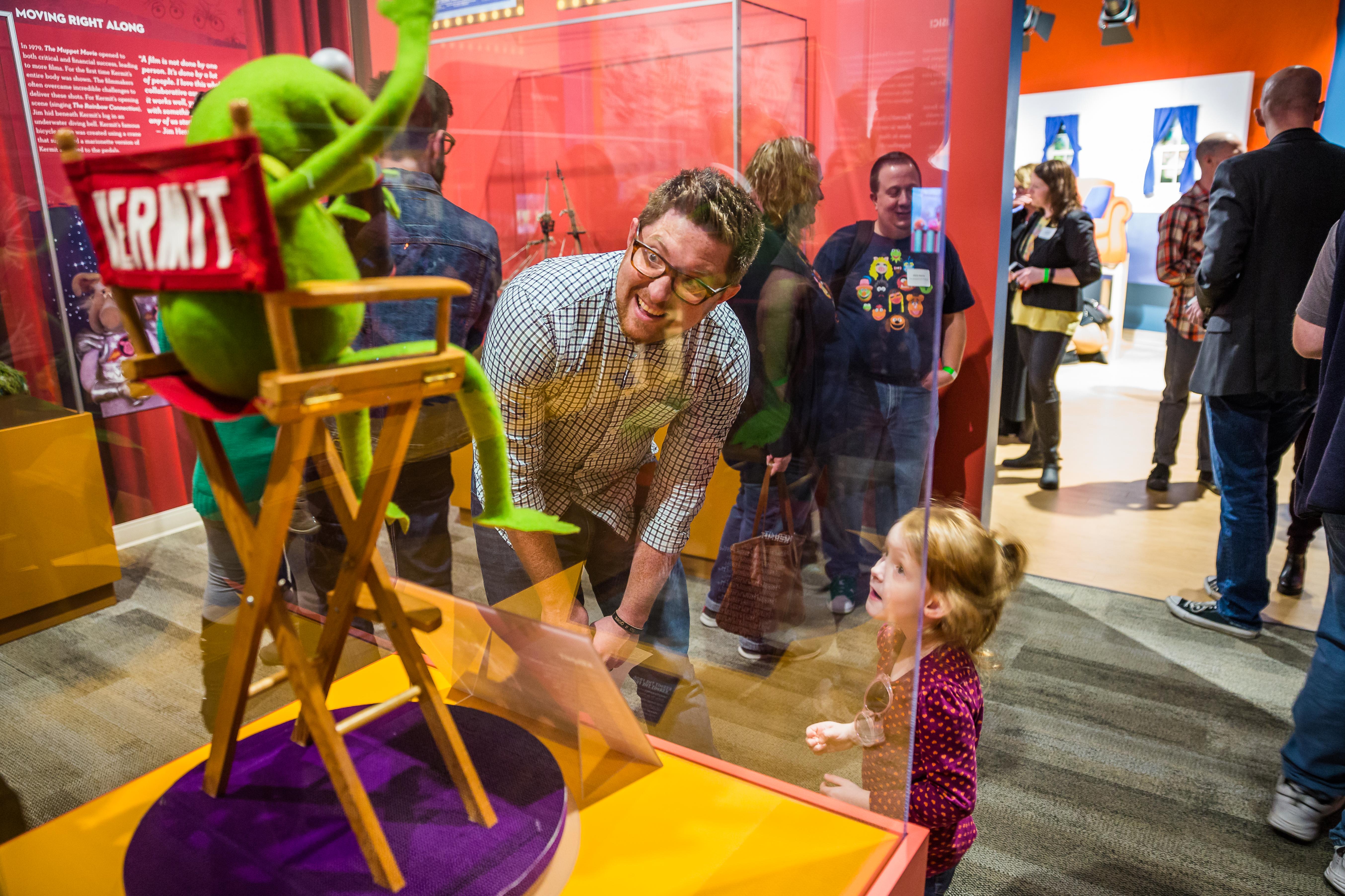 Glass enclosure with Kermit the frog displayed