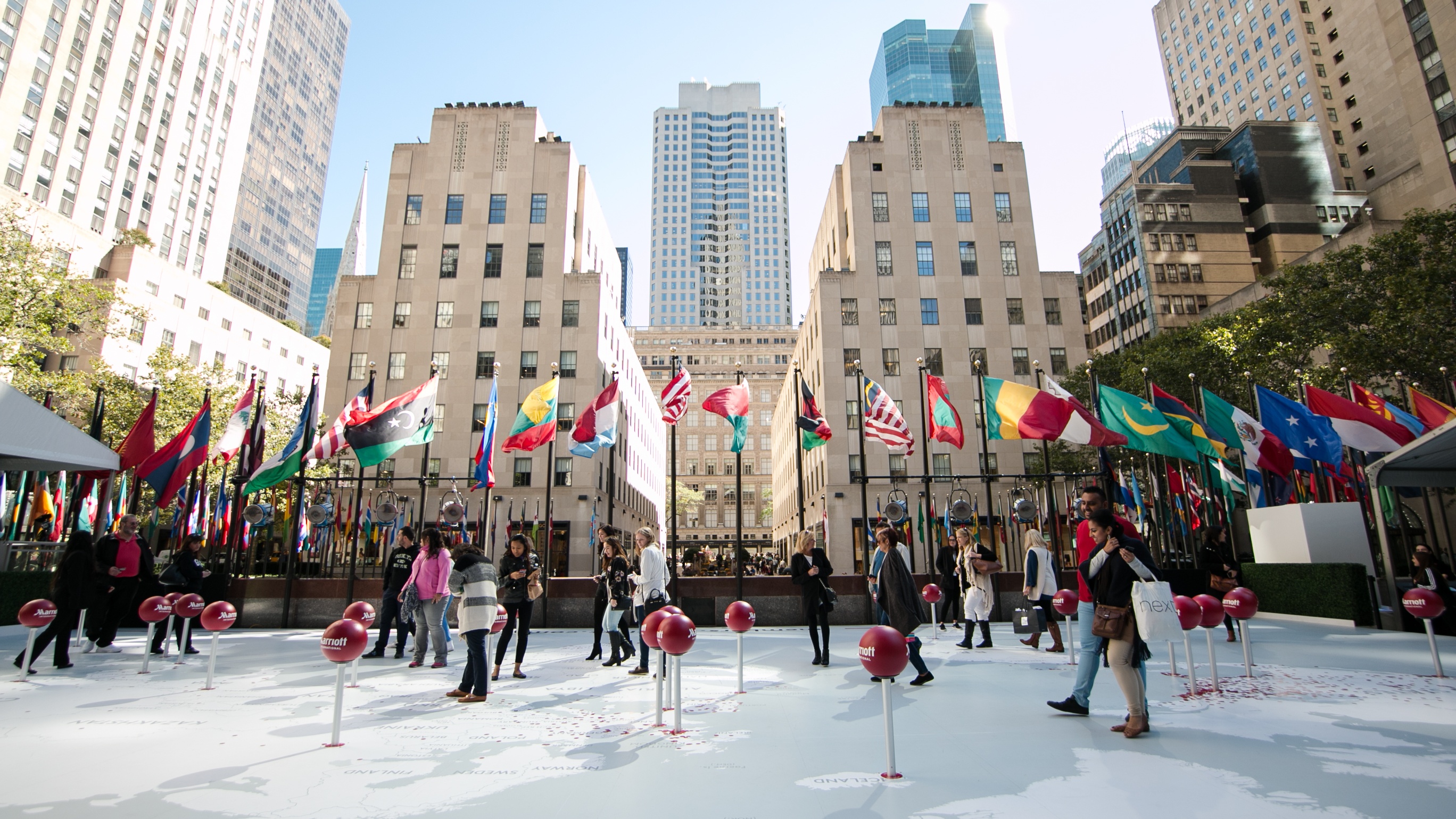 Rockefeller Center with flags of different countries and pins on ground