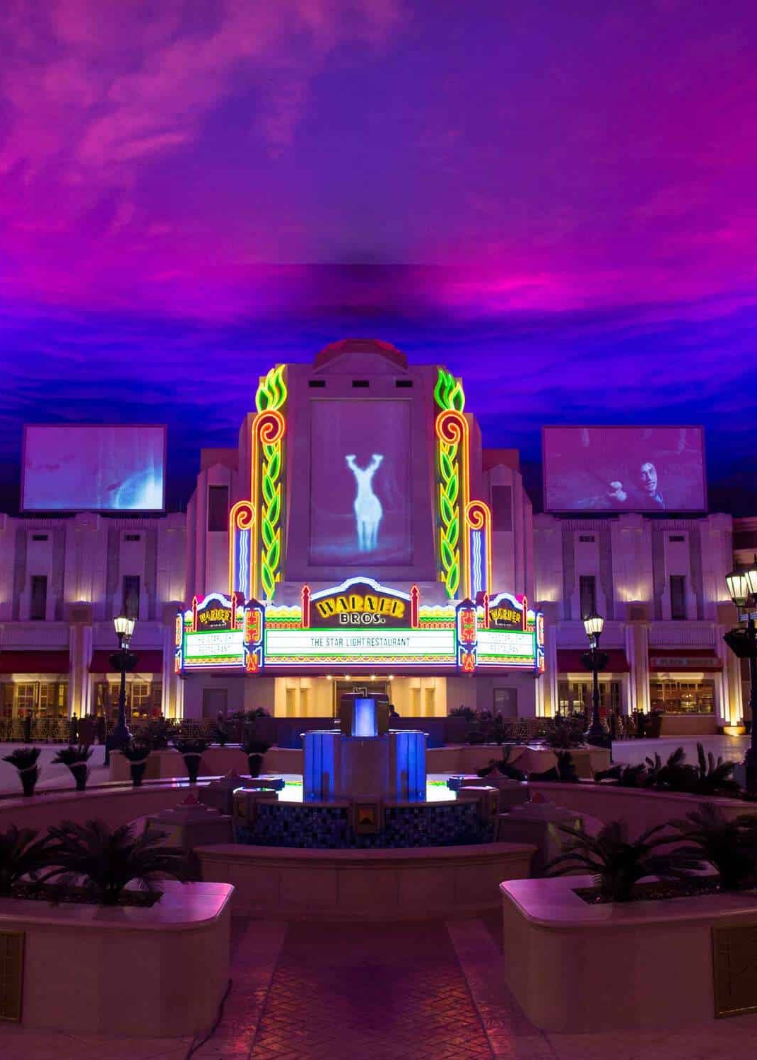 entrance to a retro movie theatre with neon lights