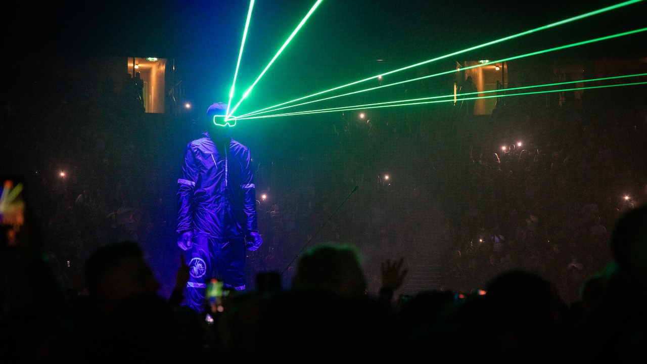 Huge sculpture of man in black overalls shooting lasers from goggles