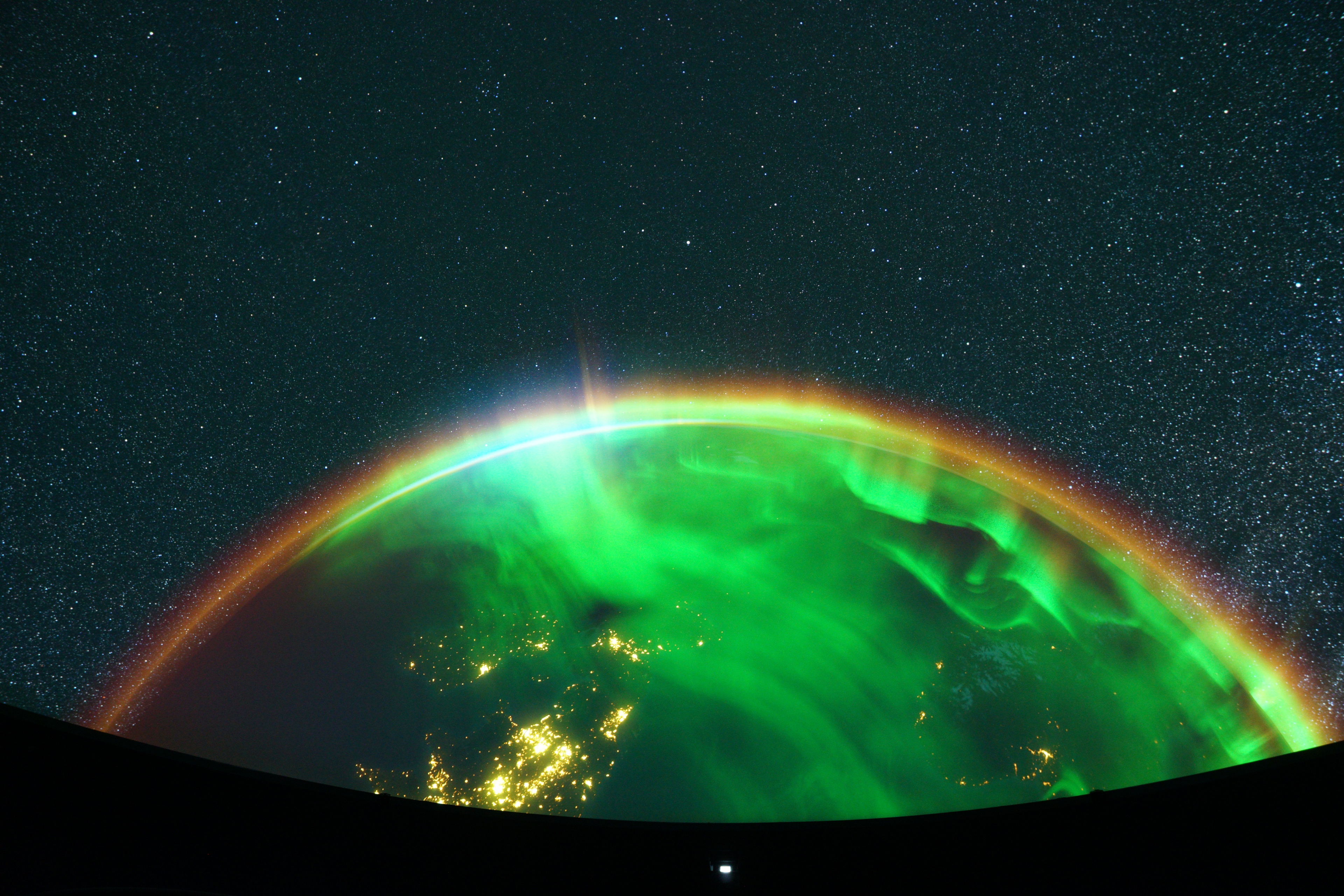 Planetarium screen with glowing green planet