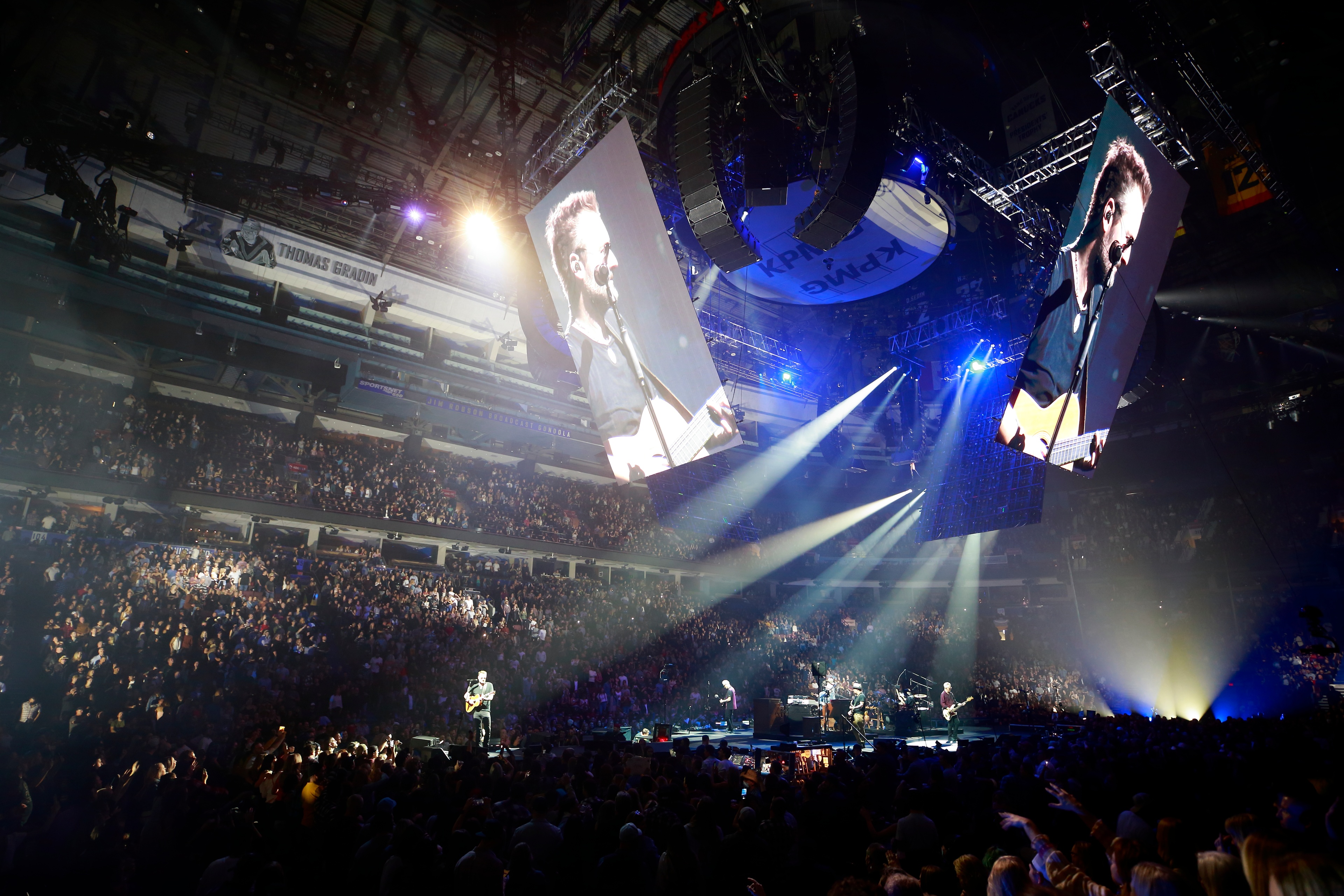 view from the stands featuring the screens hanging from the ceiling showcasing Erich Church perform at the Gather Again Tour