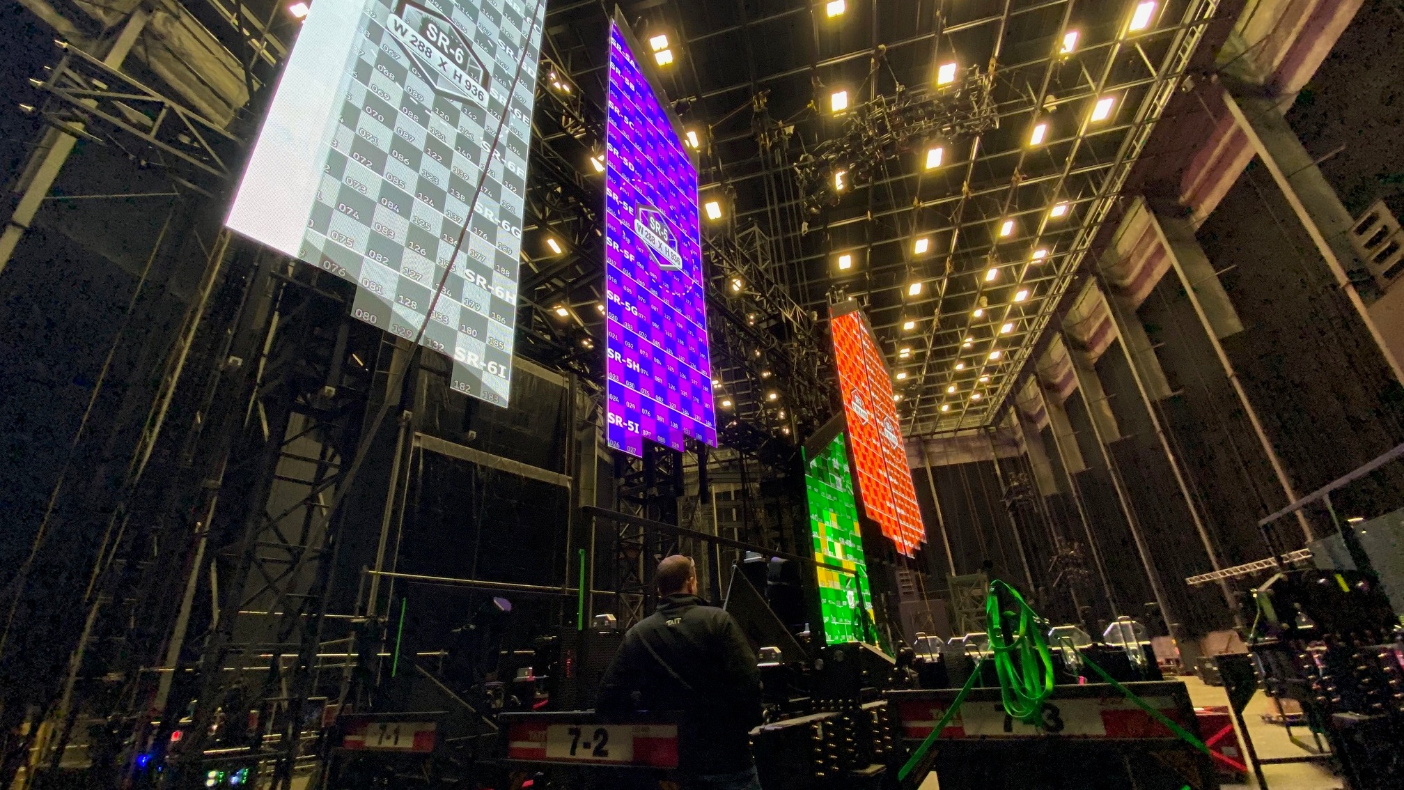 Large installation with people doing test runs on LED screens