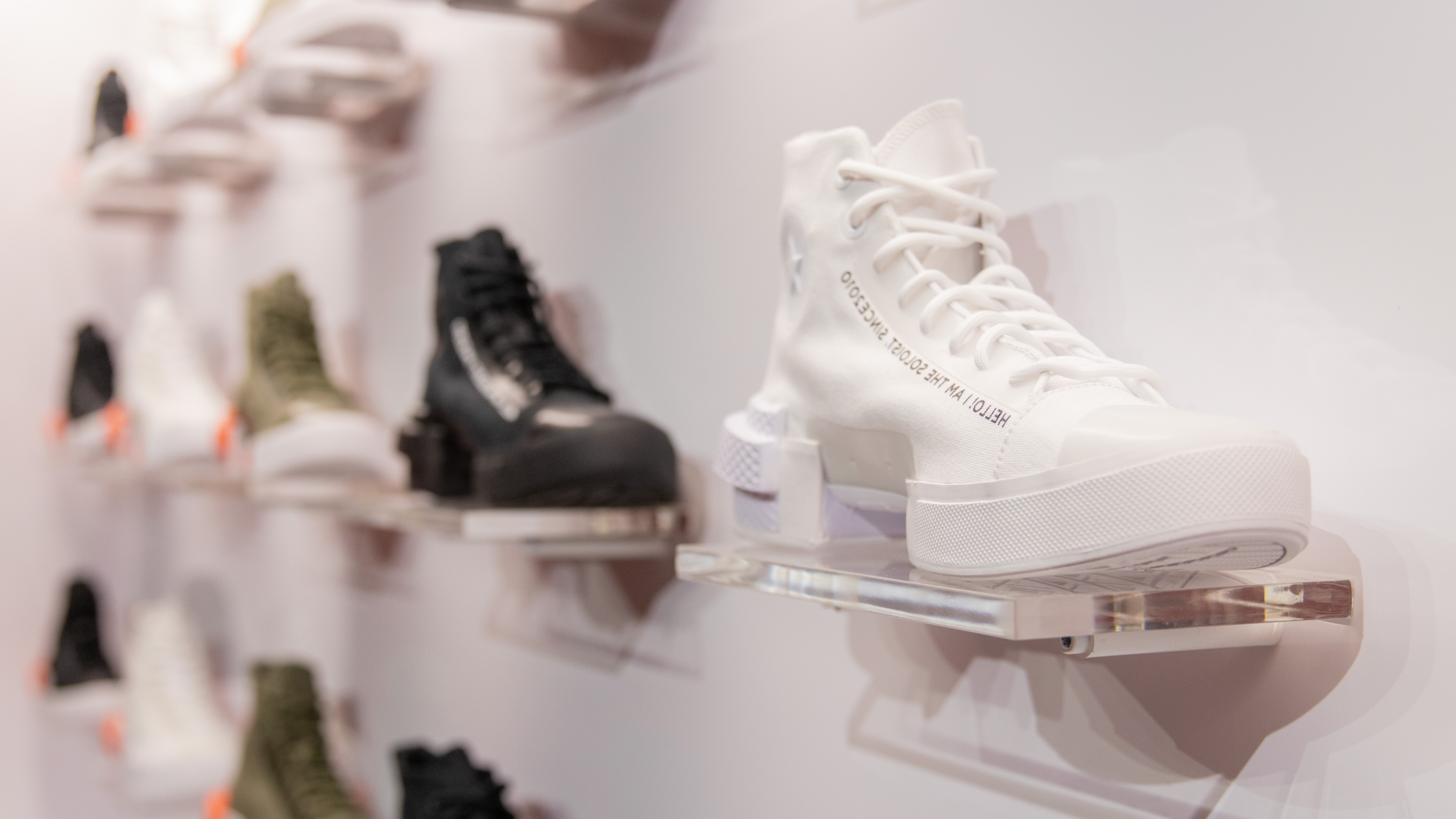 Close up shot of white high top Converse shoe