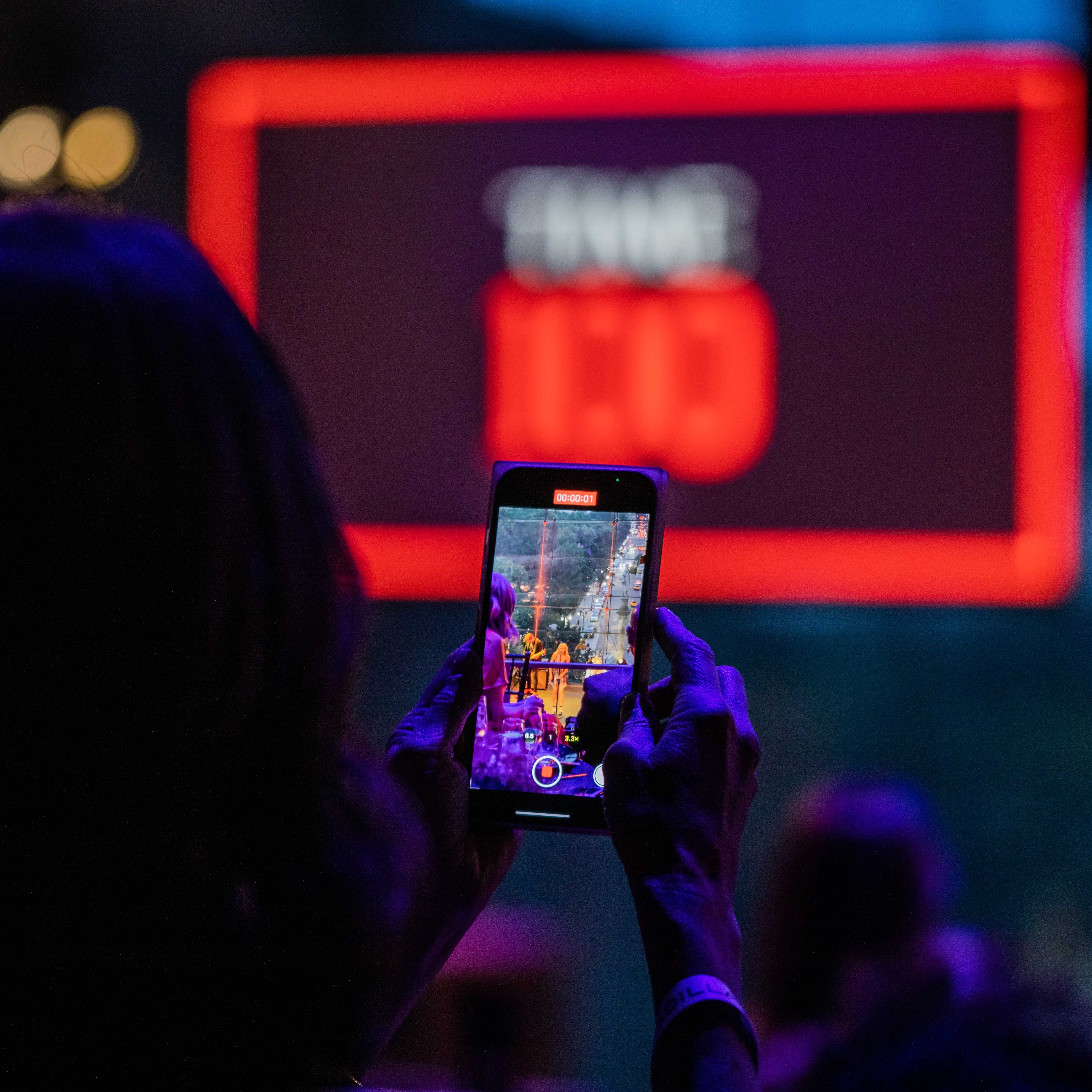 Person with cell phone recording the TIME100 Gala