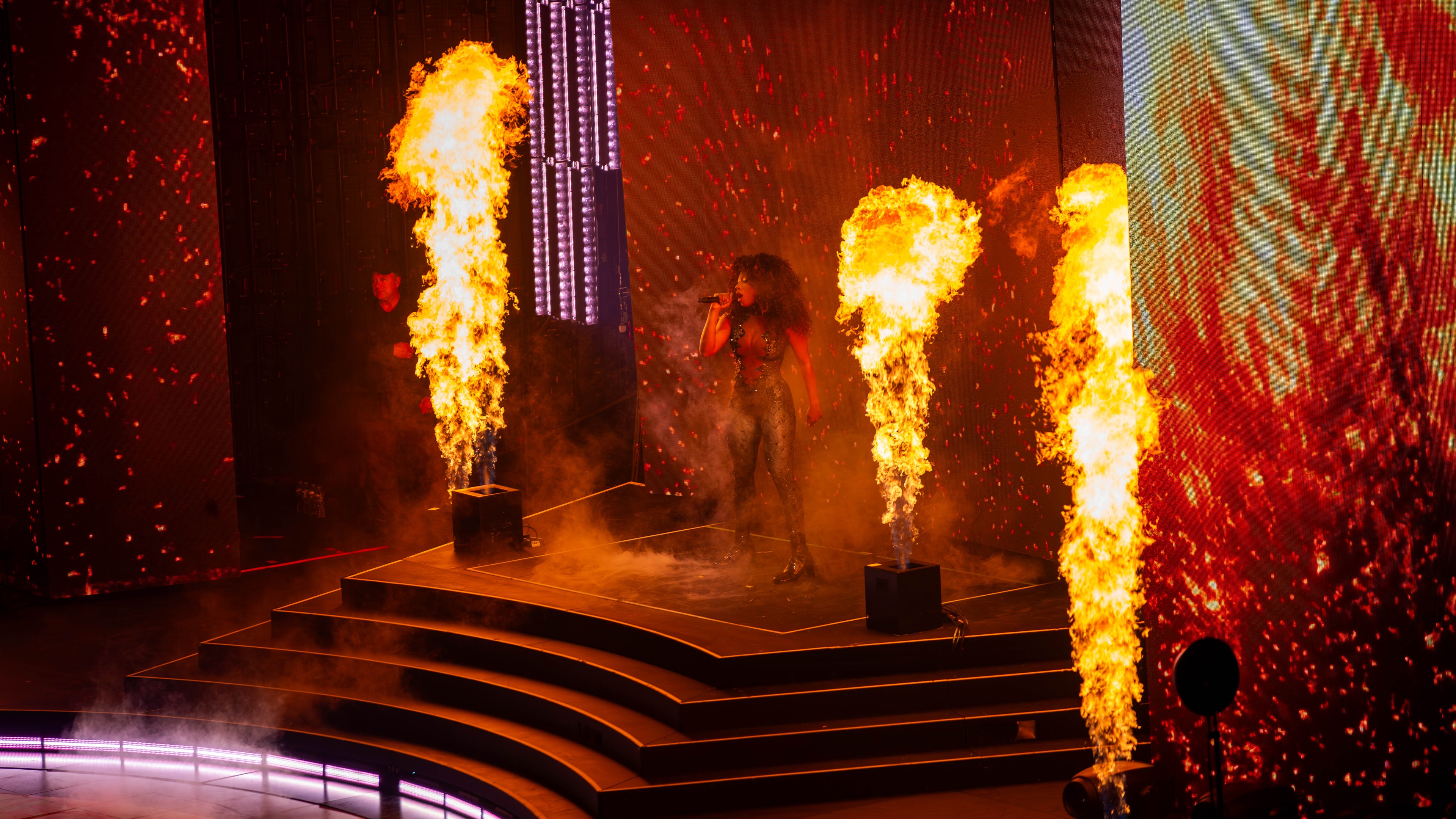 Megan thee Stallion on stage with flames shooting up around her