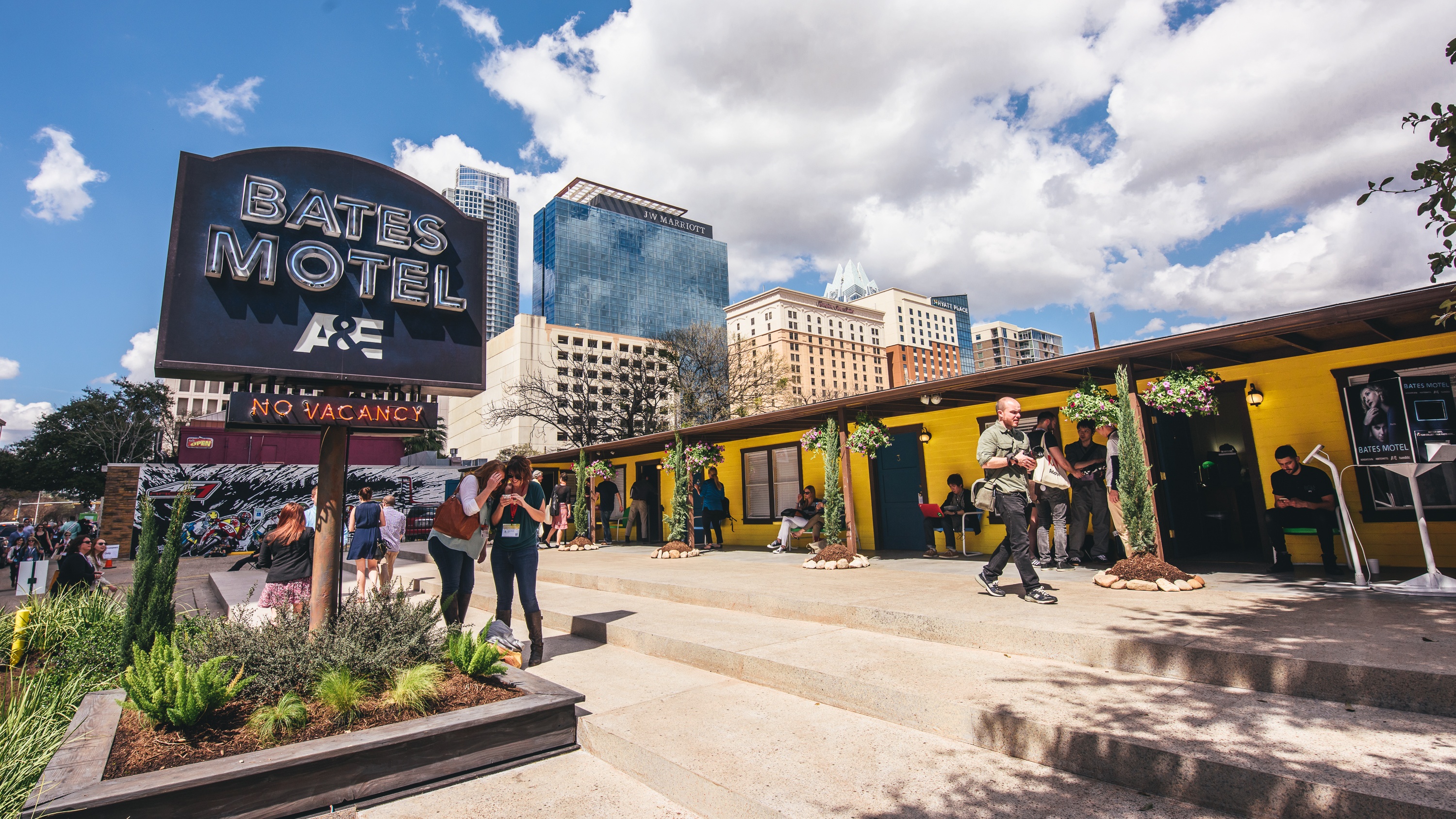 yellow Bates Motel with "no vacancy" sign and crowd hanging out at SXSW