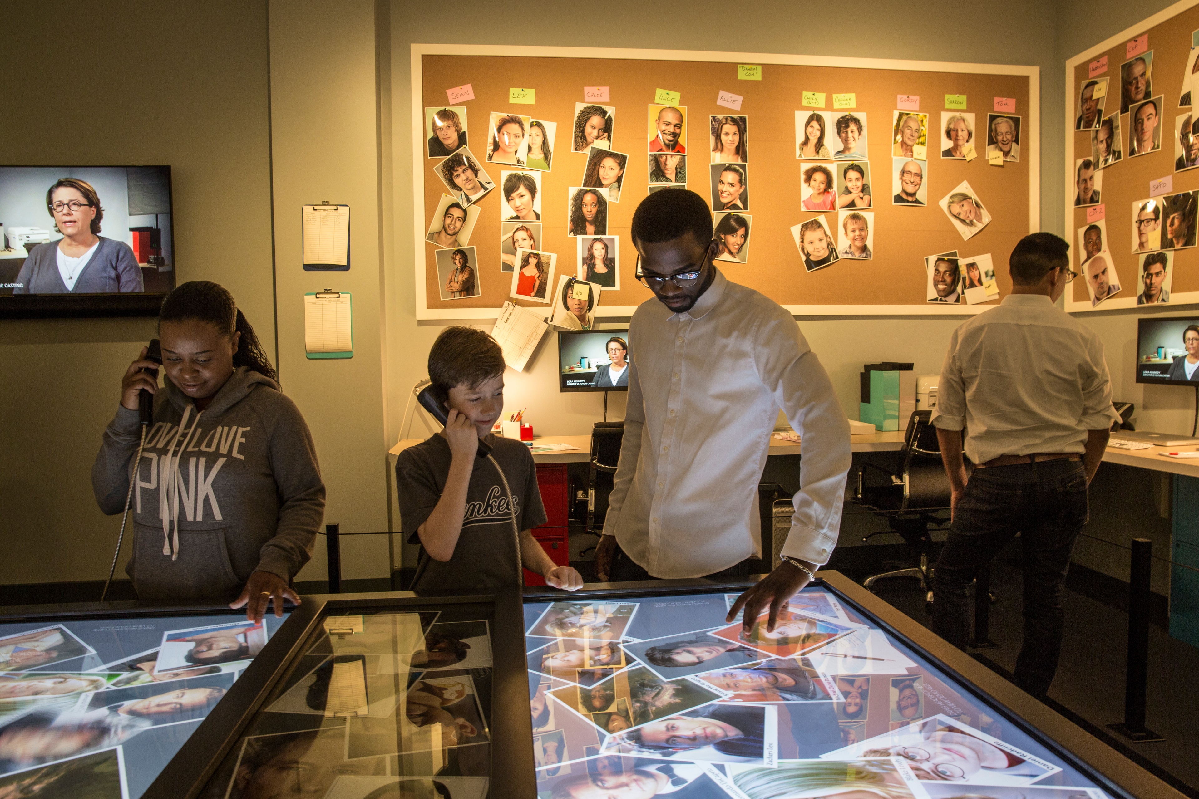 Man and child interacting with LED screen display