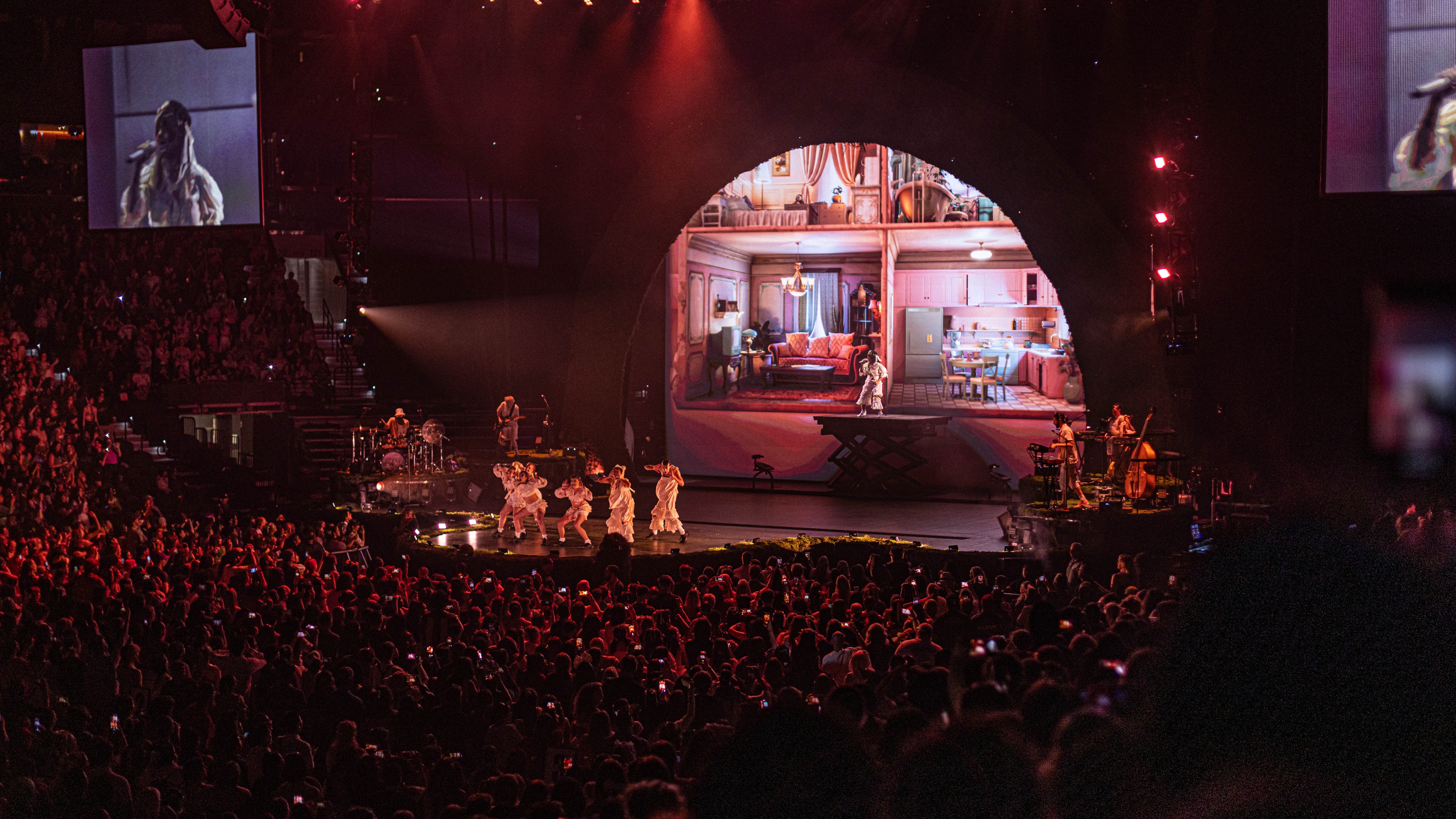 Stage with large stadium crowd and red lighting