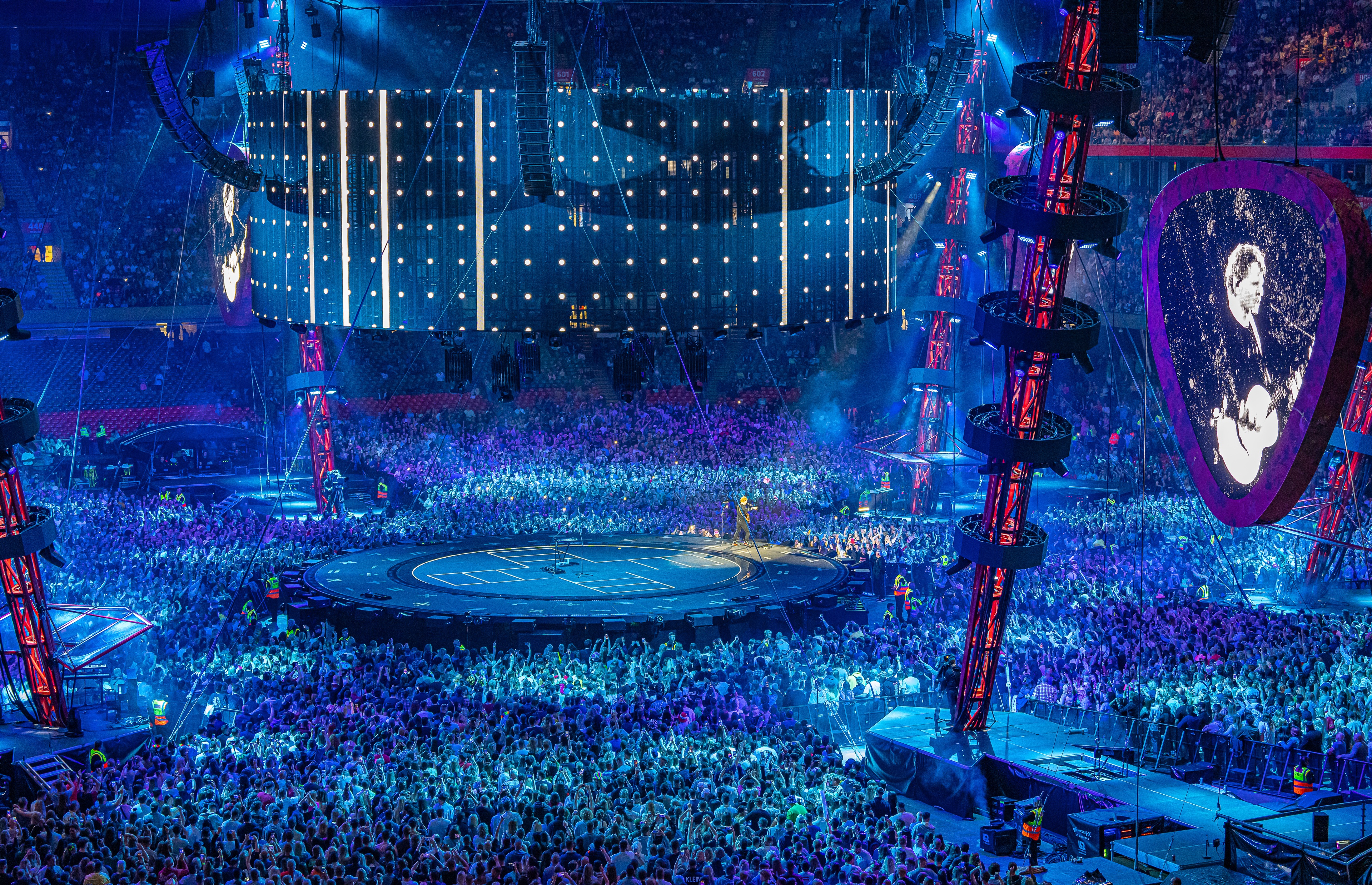 Ed Sheeran Mathematics stage lit up blue with large stadium crowd