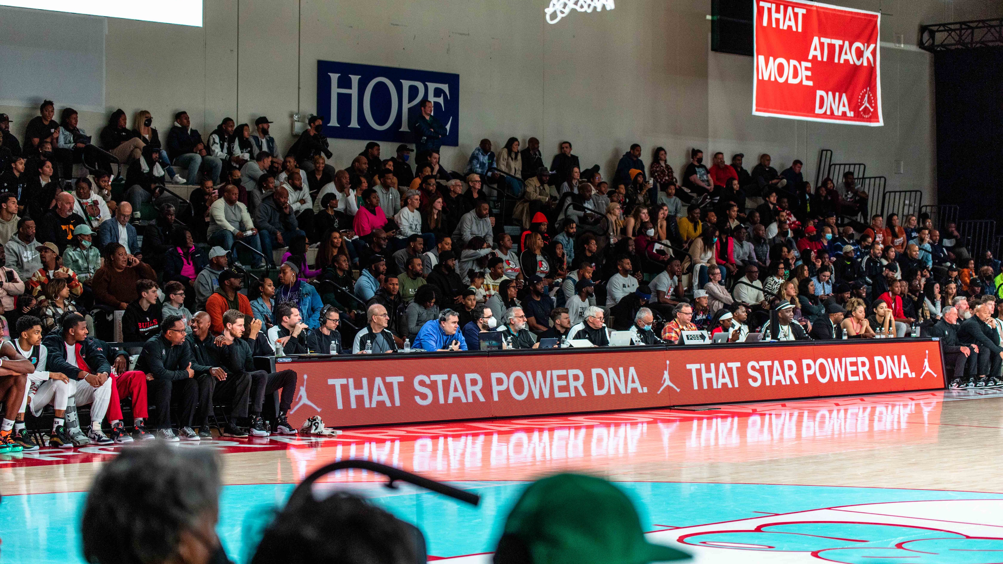 Crowd seating on bleachers watching basketball game