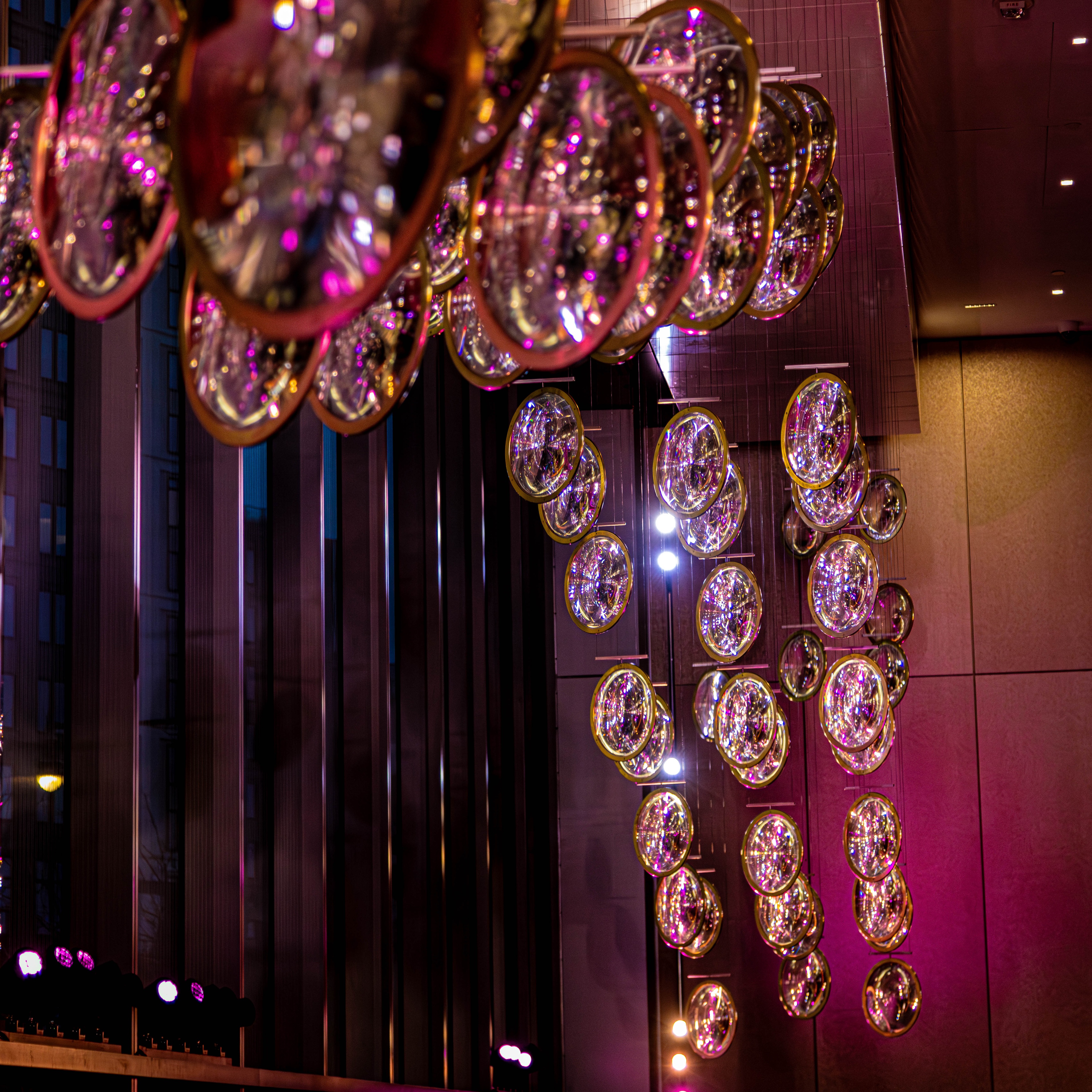 Lobby of Bristol Myers Squibb with pink accent lighting and chandelier
