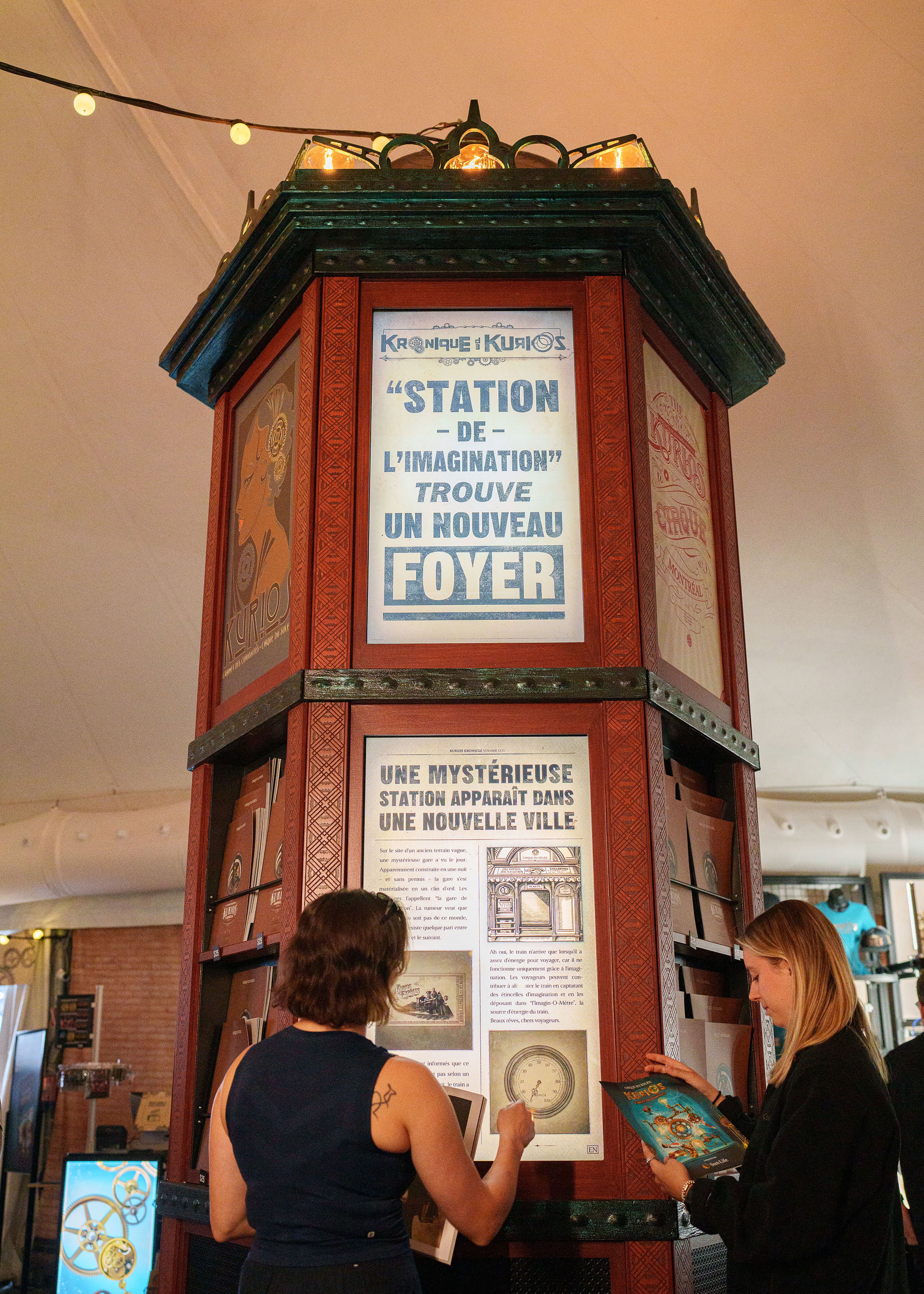 News stand object with two women reading the screen