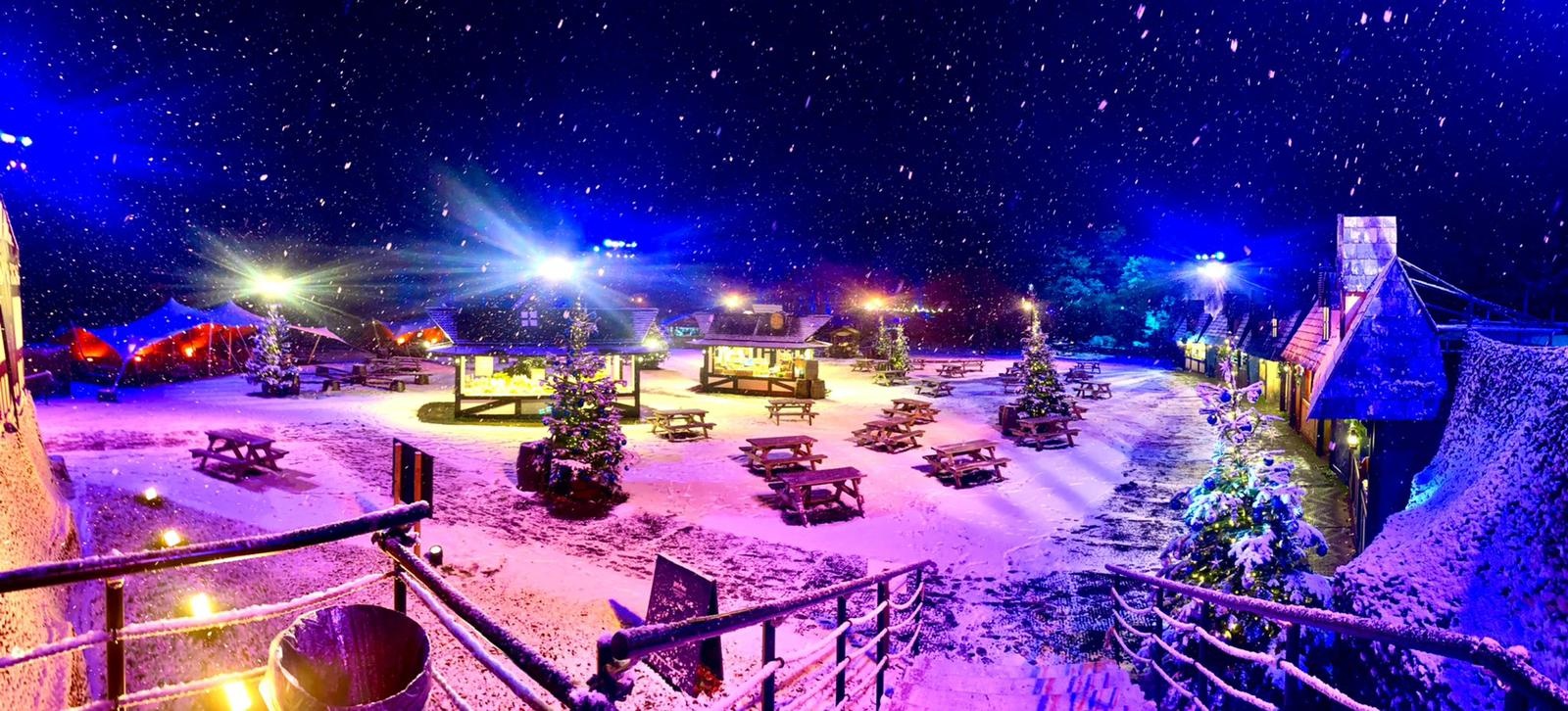 Harry Potter: A Forbidden Forest Experience Winter snowed in village with picnic tables