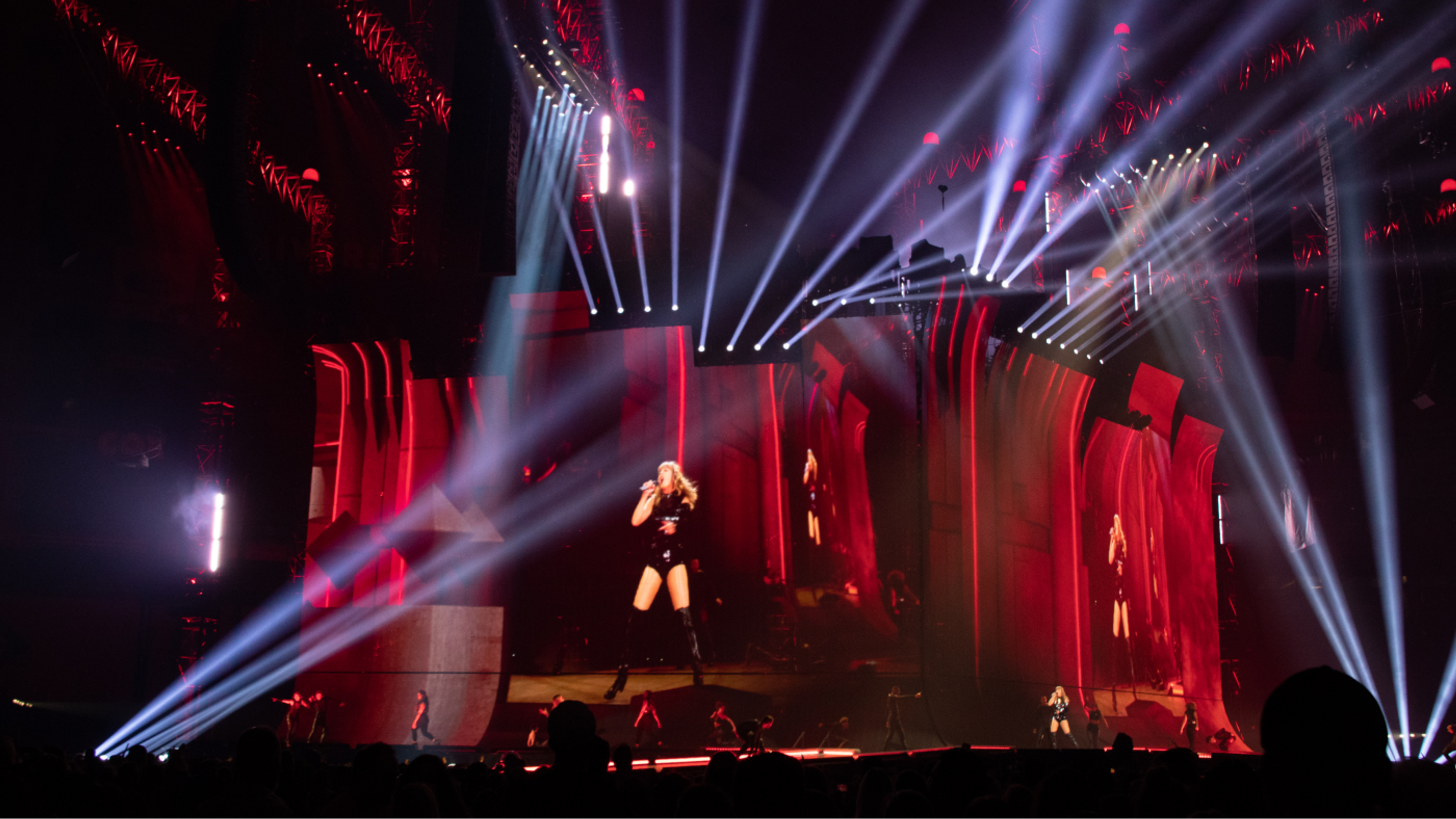 taylor swift performing, projected on stage screens