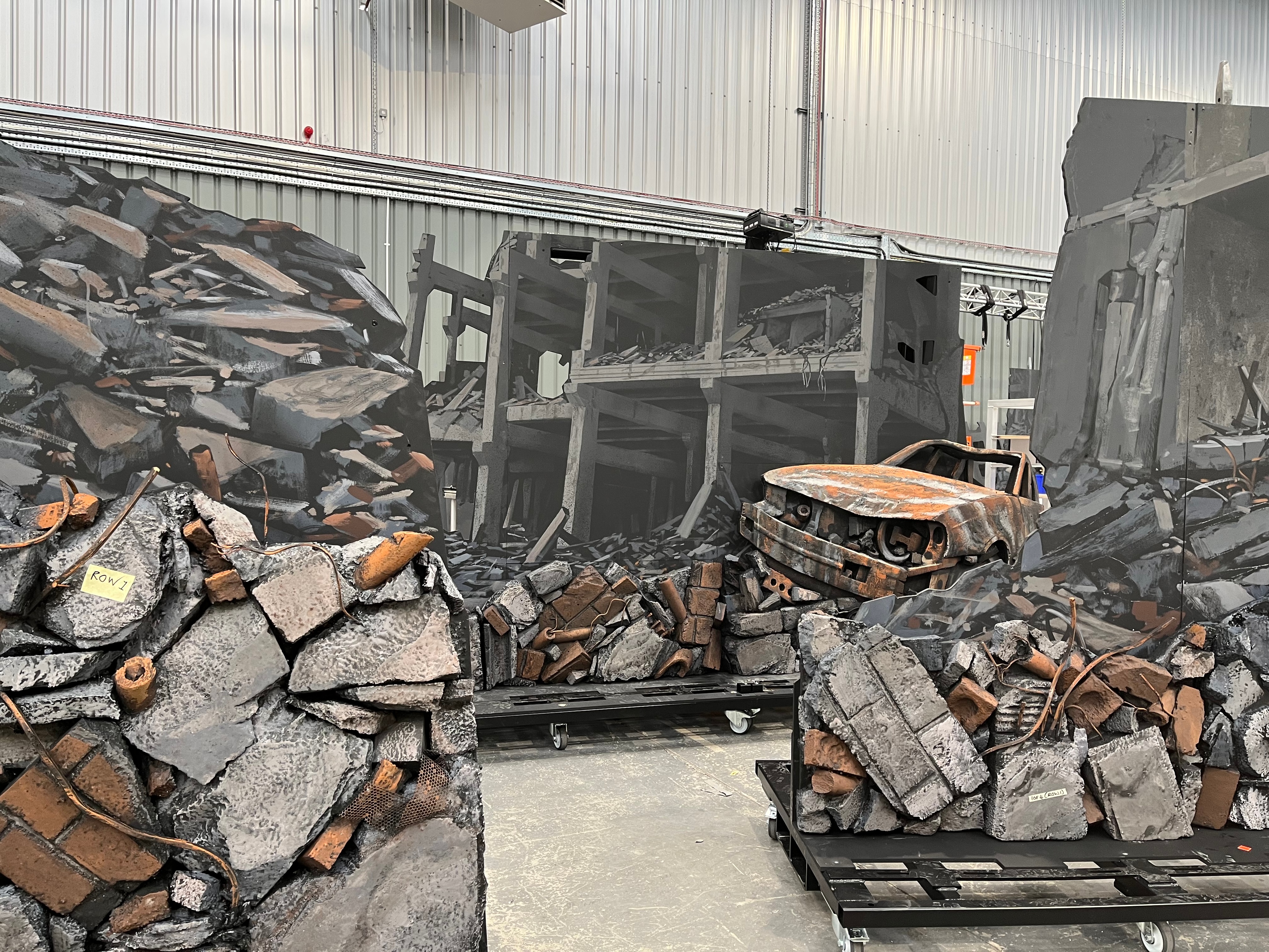 behind the scenes of My Chemical Romance Foundations Tour featuring stage scenery build including debris, torn building, and a broken abandoned car