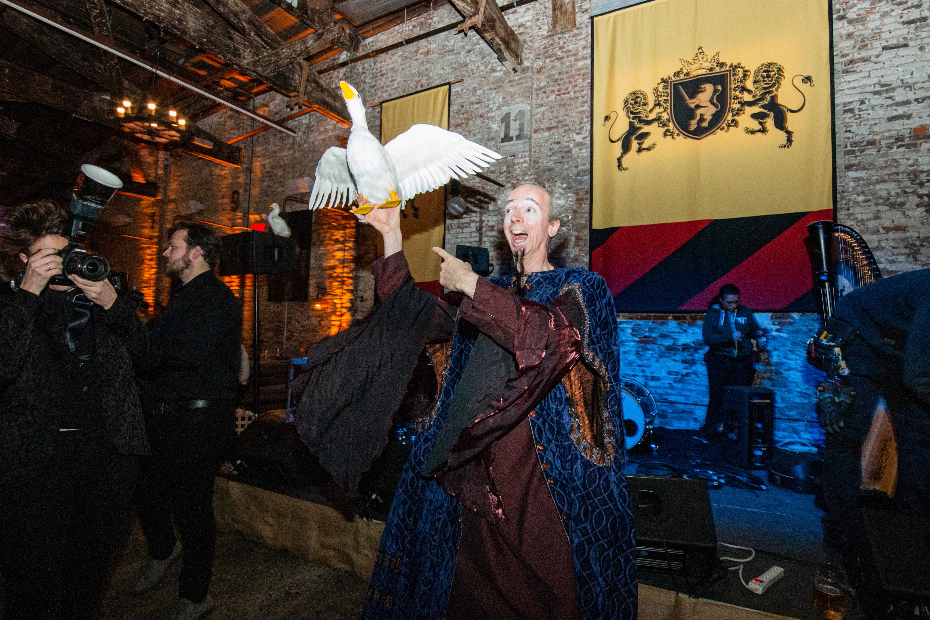 Man holding goose and pointing to it