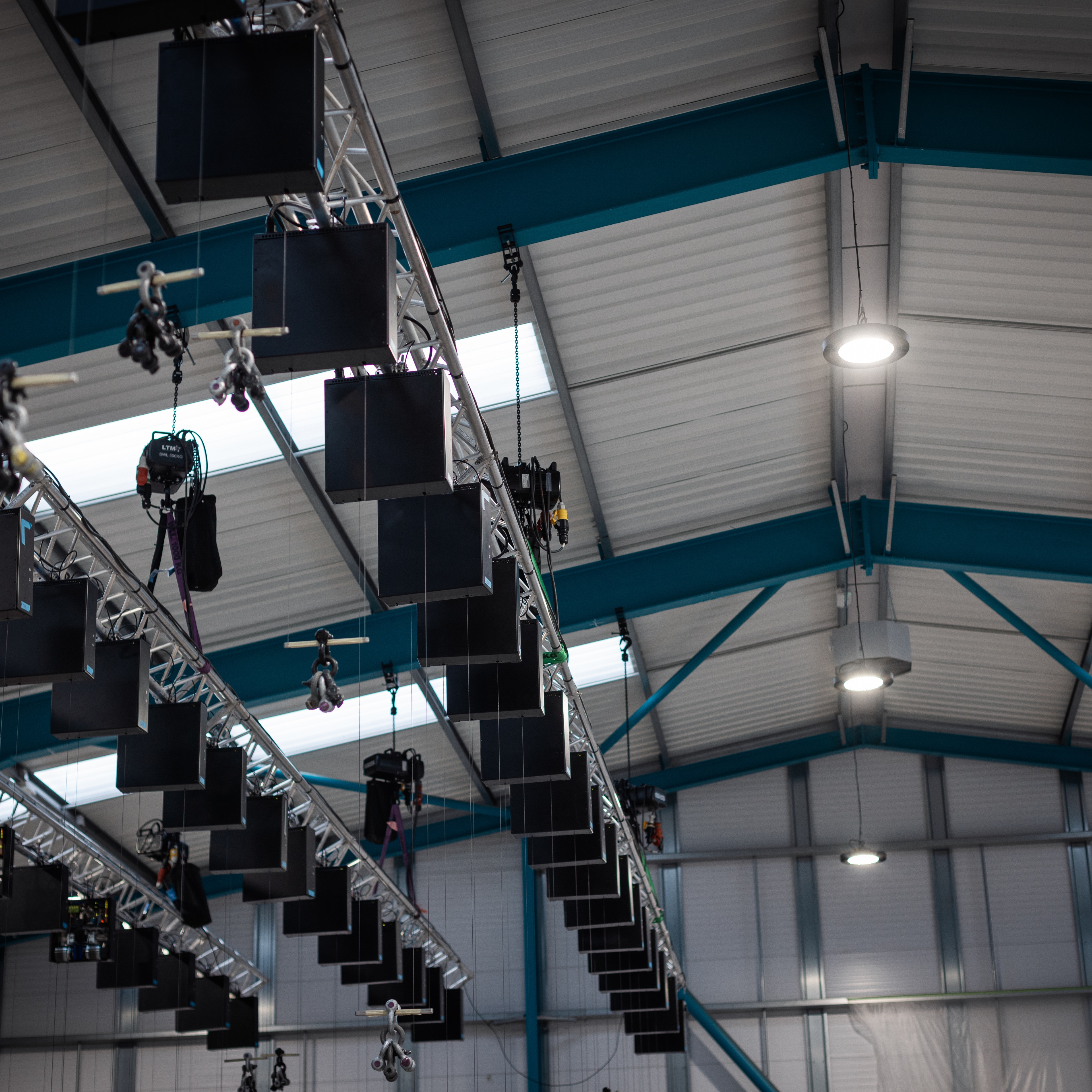 Overhead shot of winch hanging from ceiling in shop