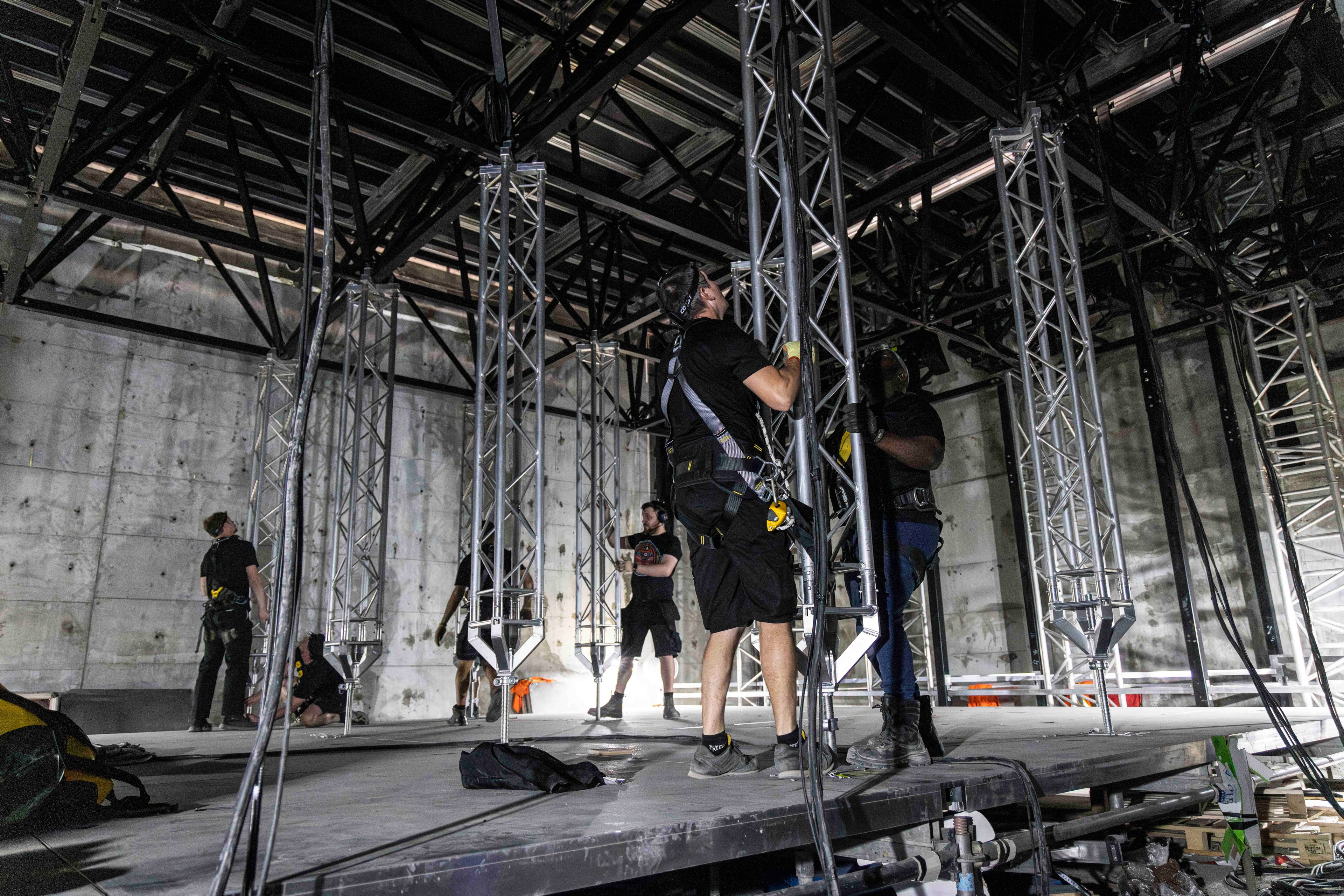 TAIT team members working on stage lift