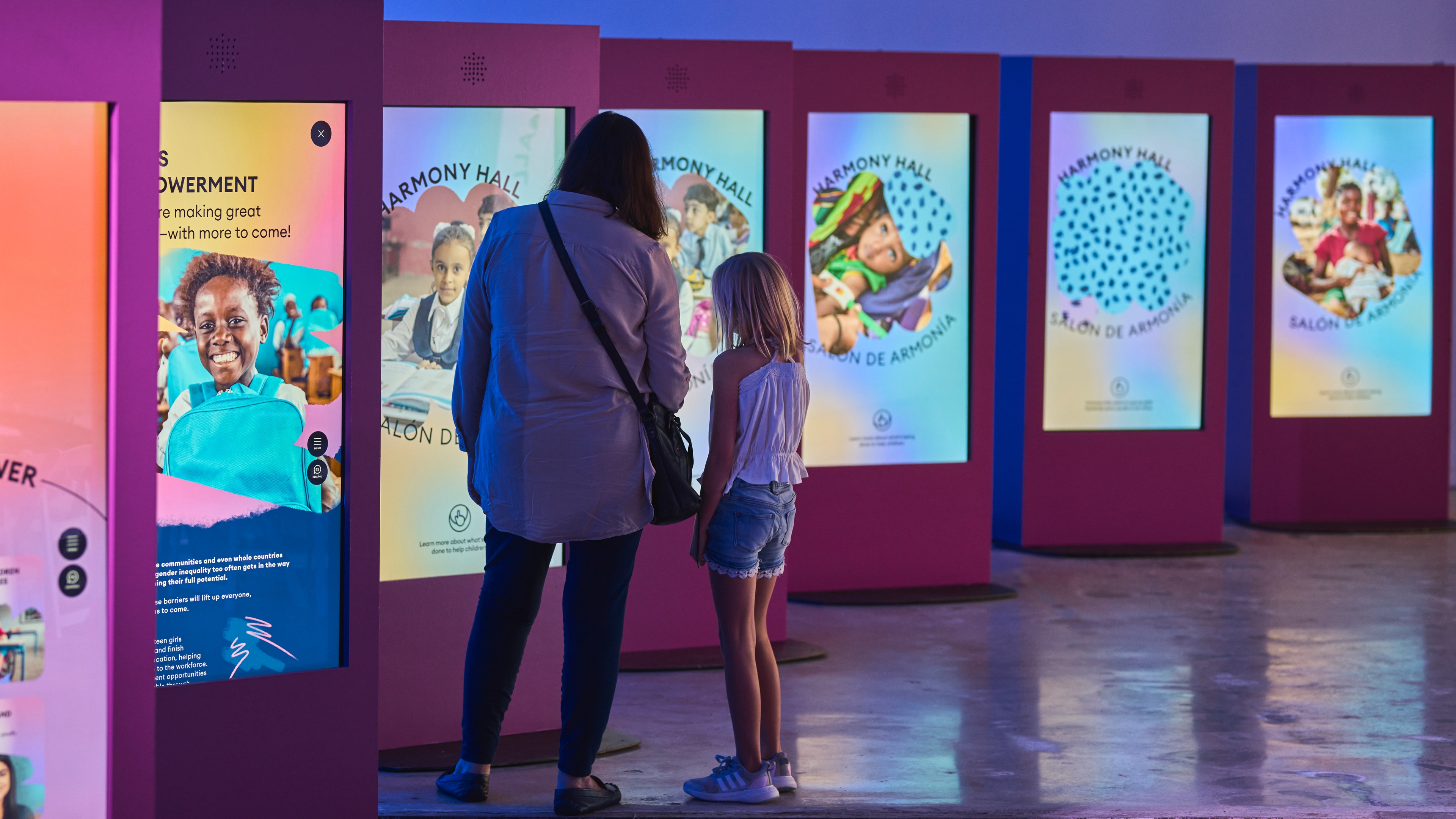 Woman and young girl looking at LED display