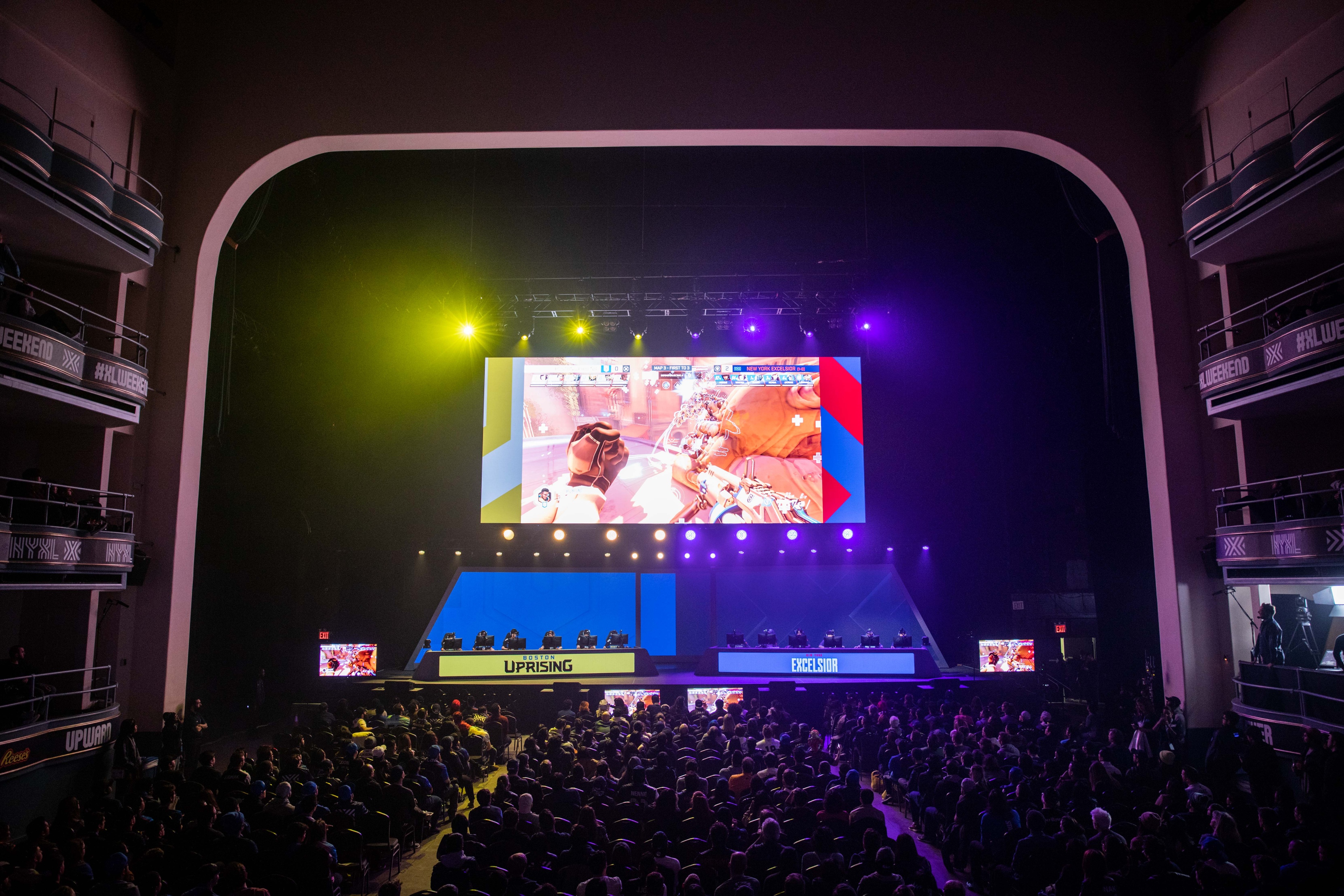 Wide shot of main stage of competition with blue and yellow lighting