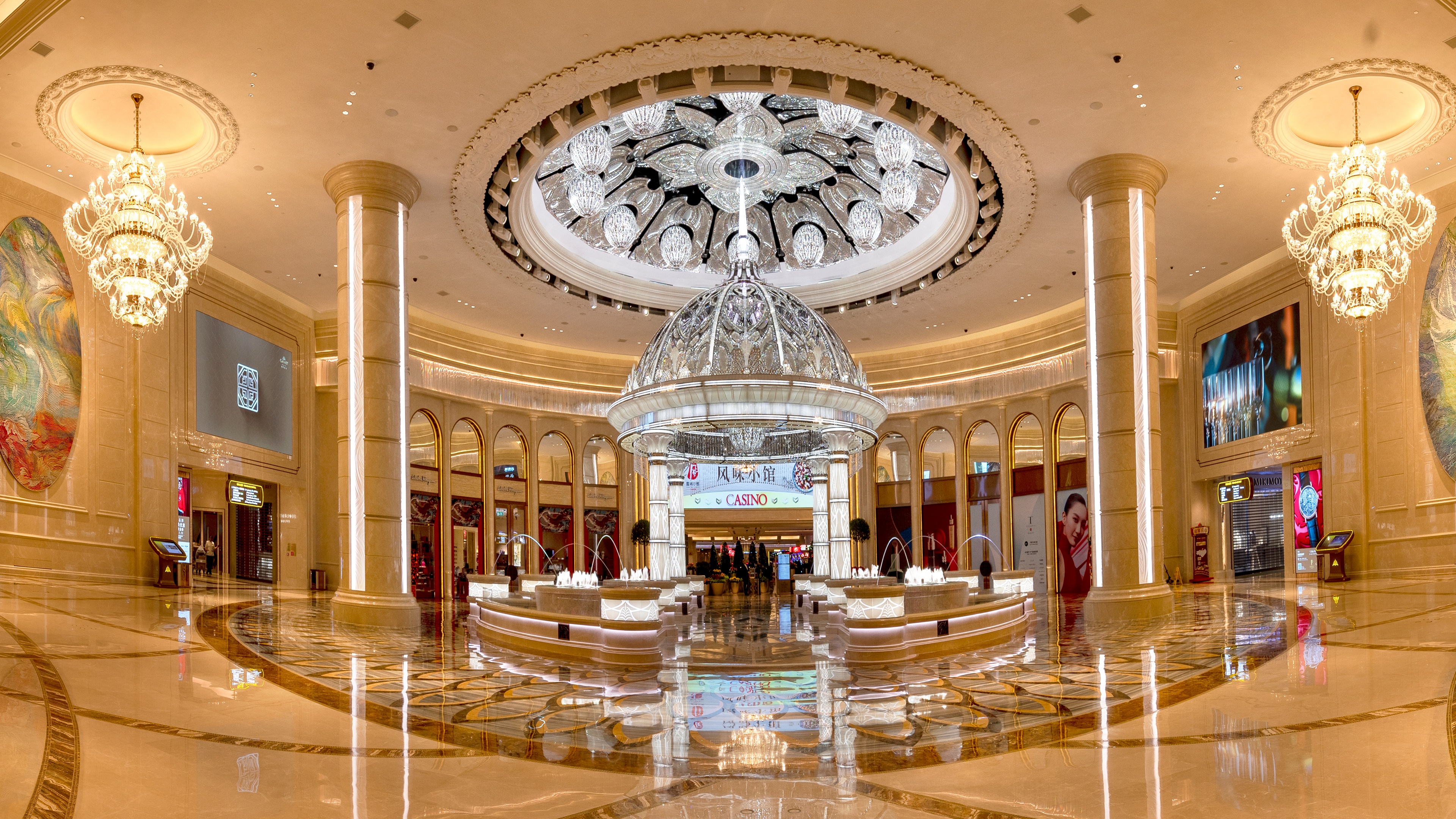 Architectural kinetic Lous flower sculpture installed in centre of grand lobby with chandeliers and light displays