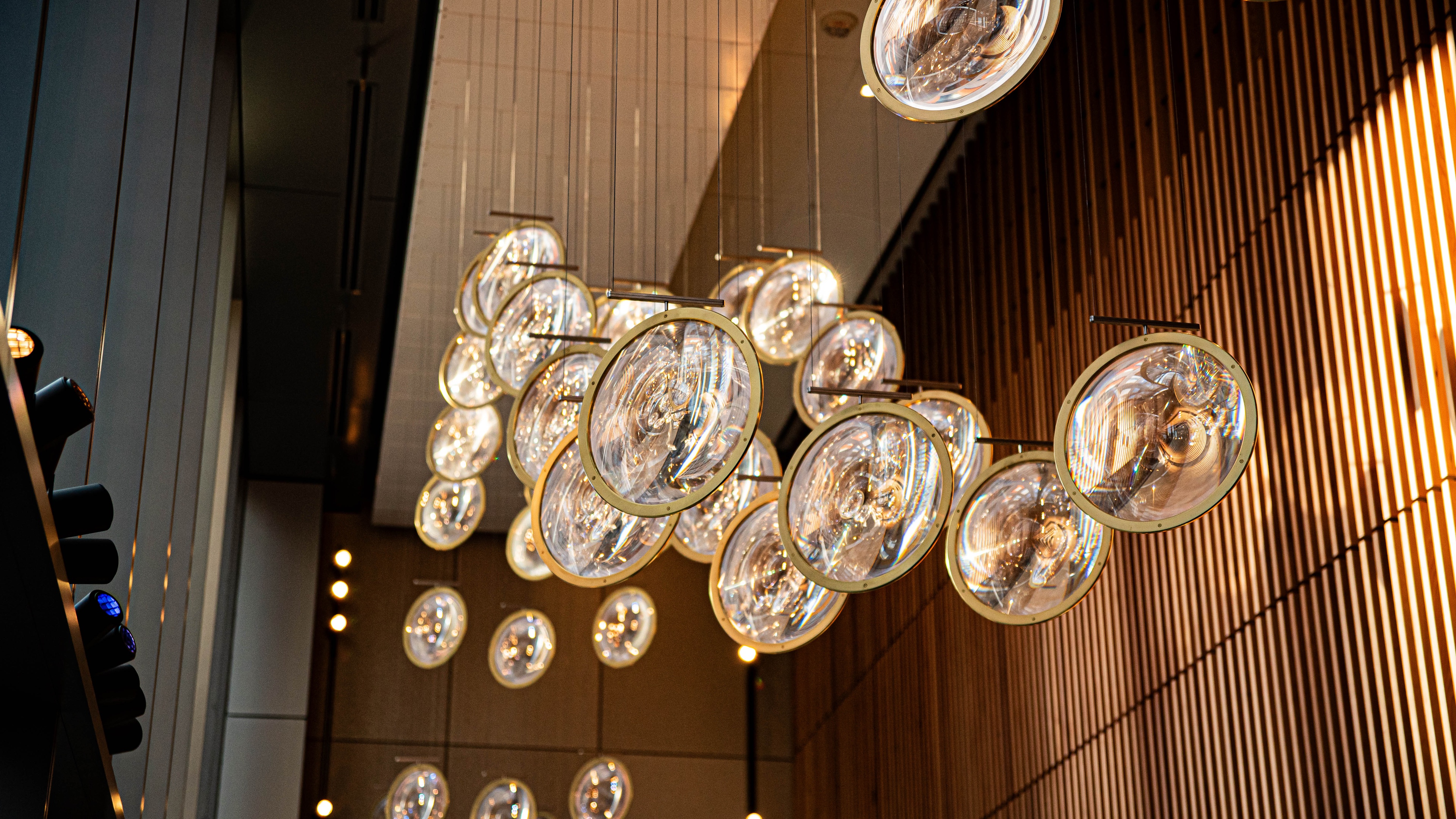Close up shot of round glass circles that encompass chandelier