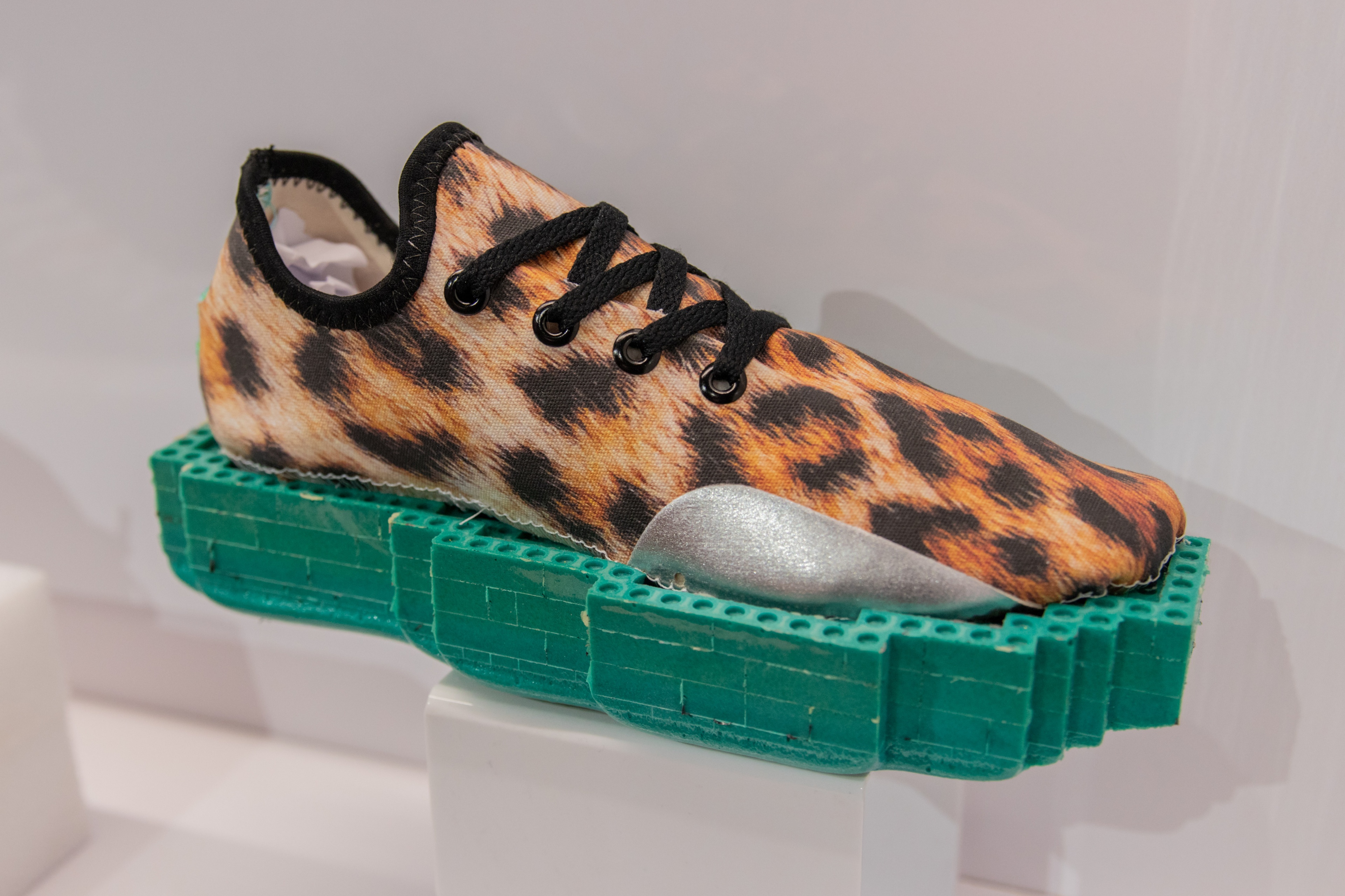Close up shot of cheetah print shoe with green sole
