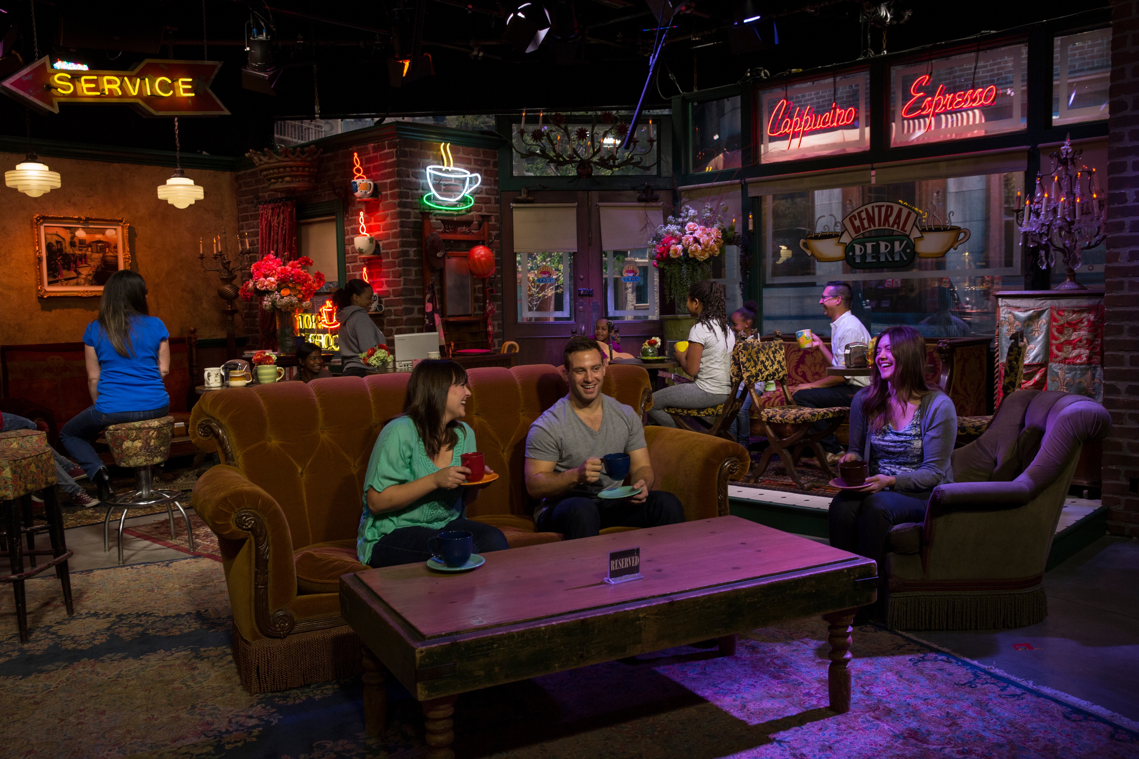 Guests sitting in mock cafe set