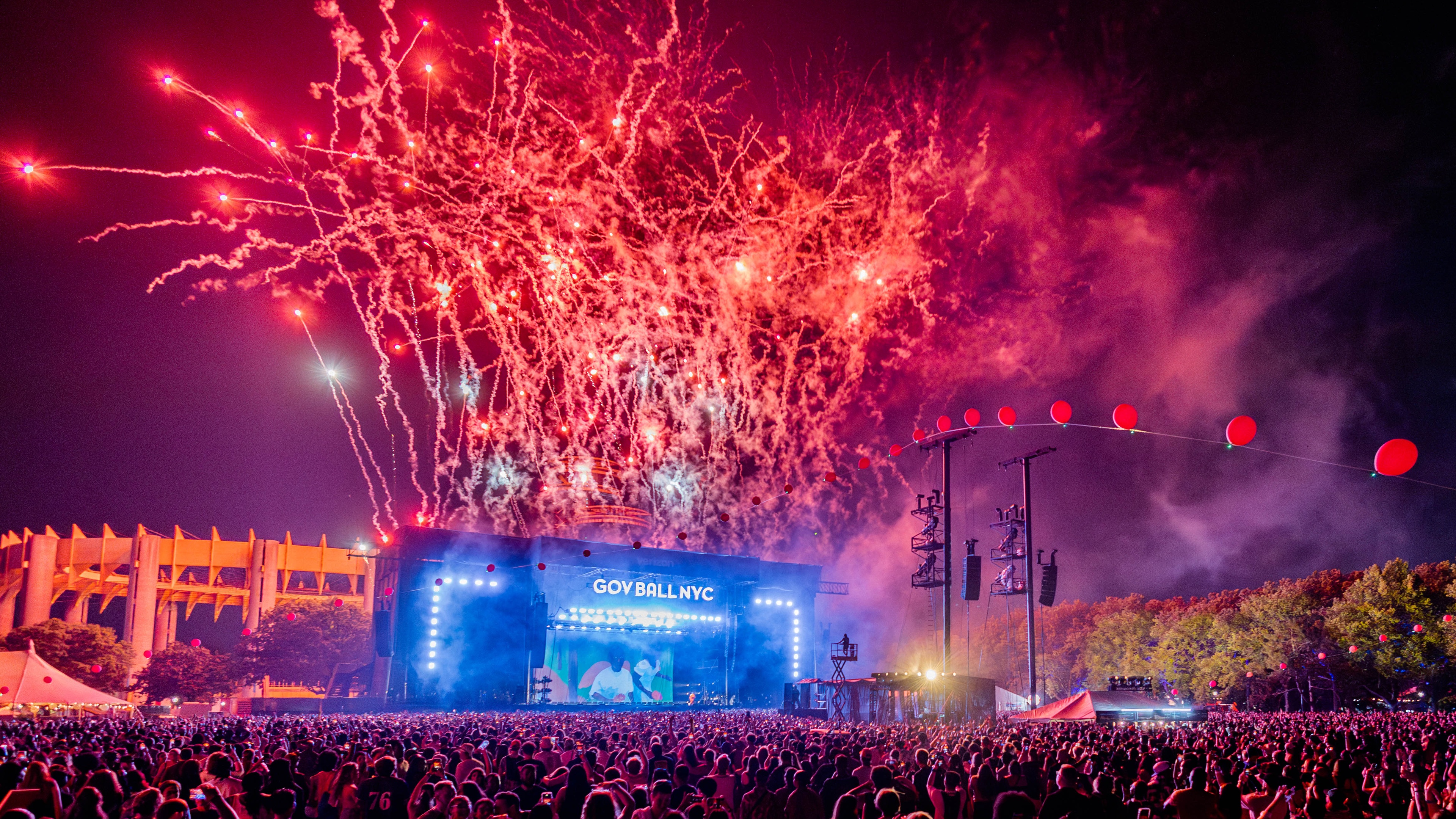 Founders Entertainment The Governors Ball at Corona Park crowd facing main stage lit up in blue with red pyros shooting to the sky