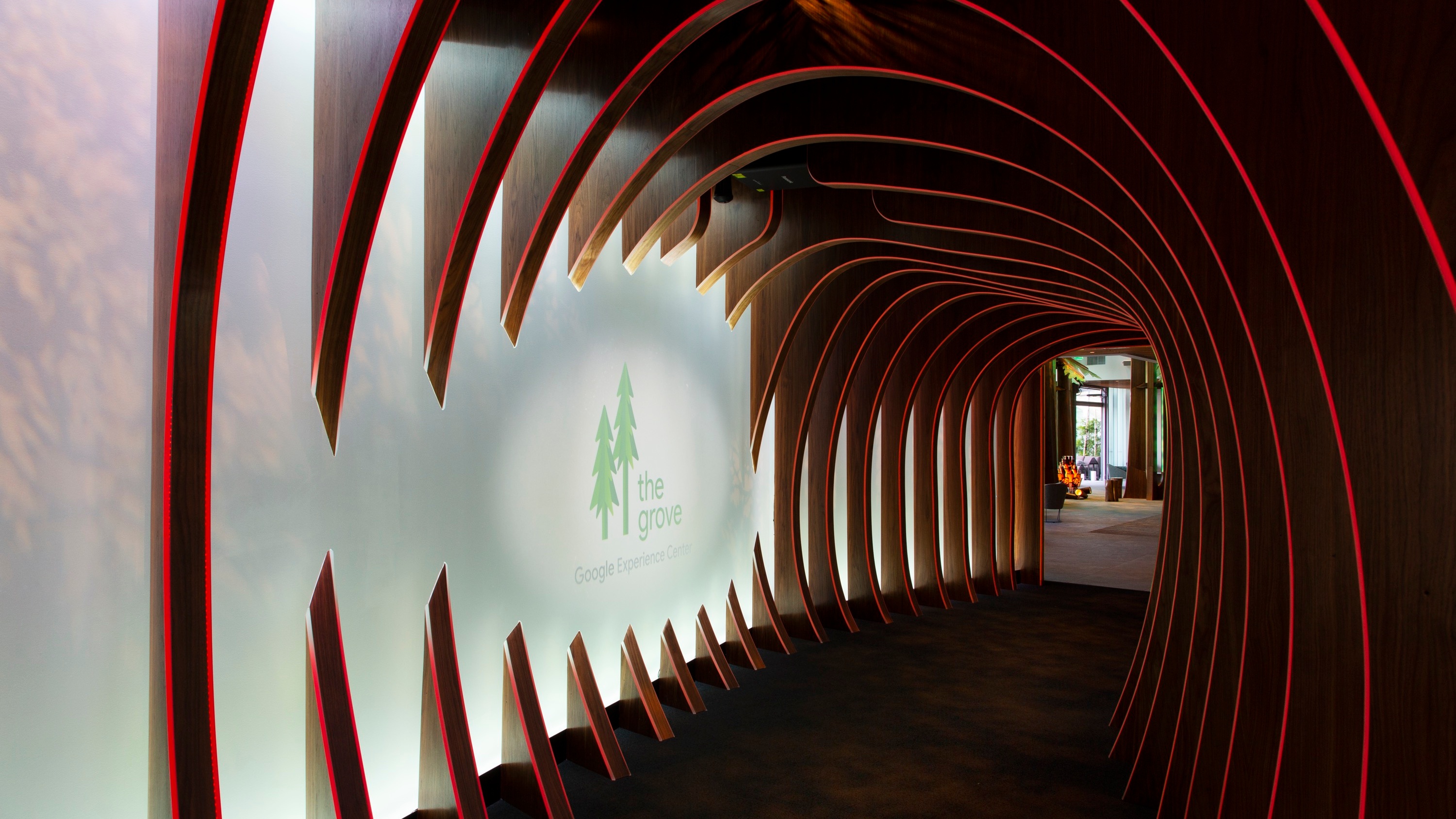 Entrance to the Grove, curved wooden arches with red LED lights