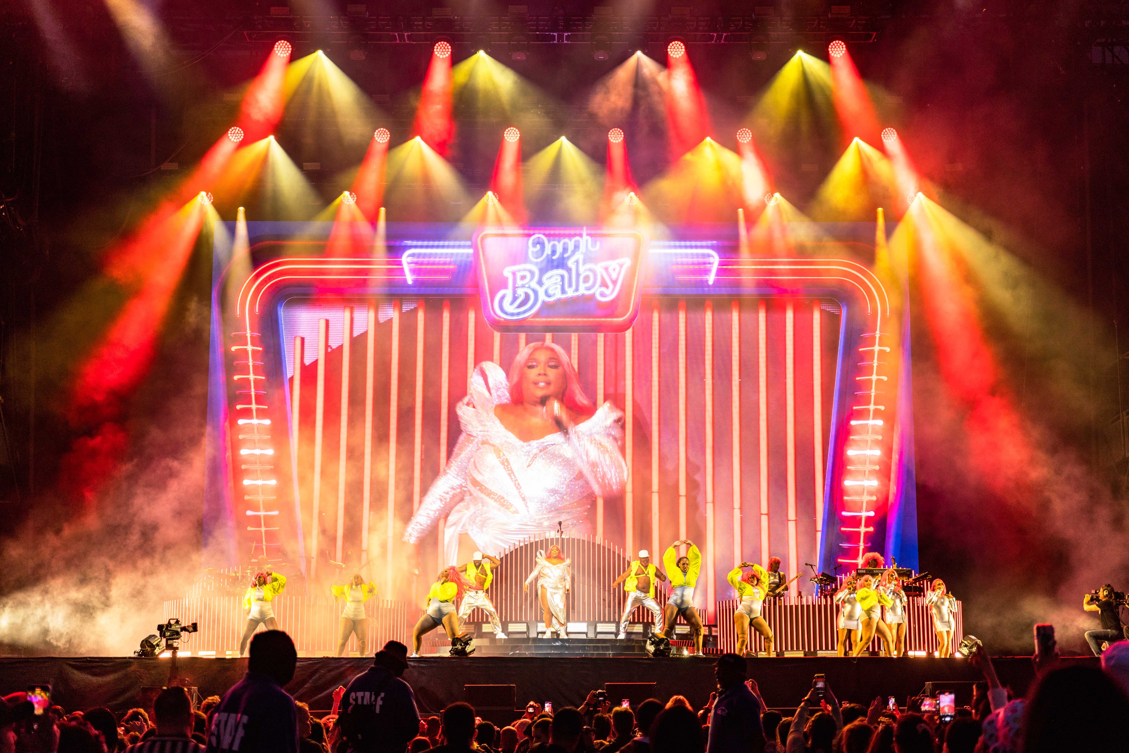 Founders Entertainment The Governors Ball at Corona Park crowd facing a stage lit up in red and yellow lights as Lizzo and backup dancers perform