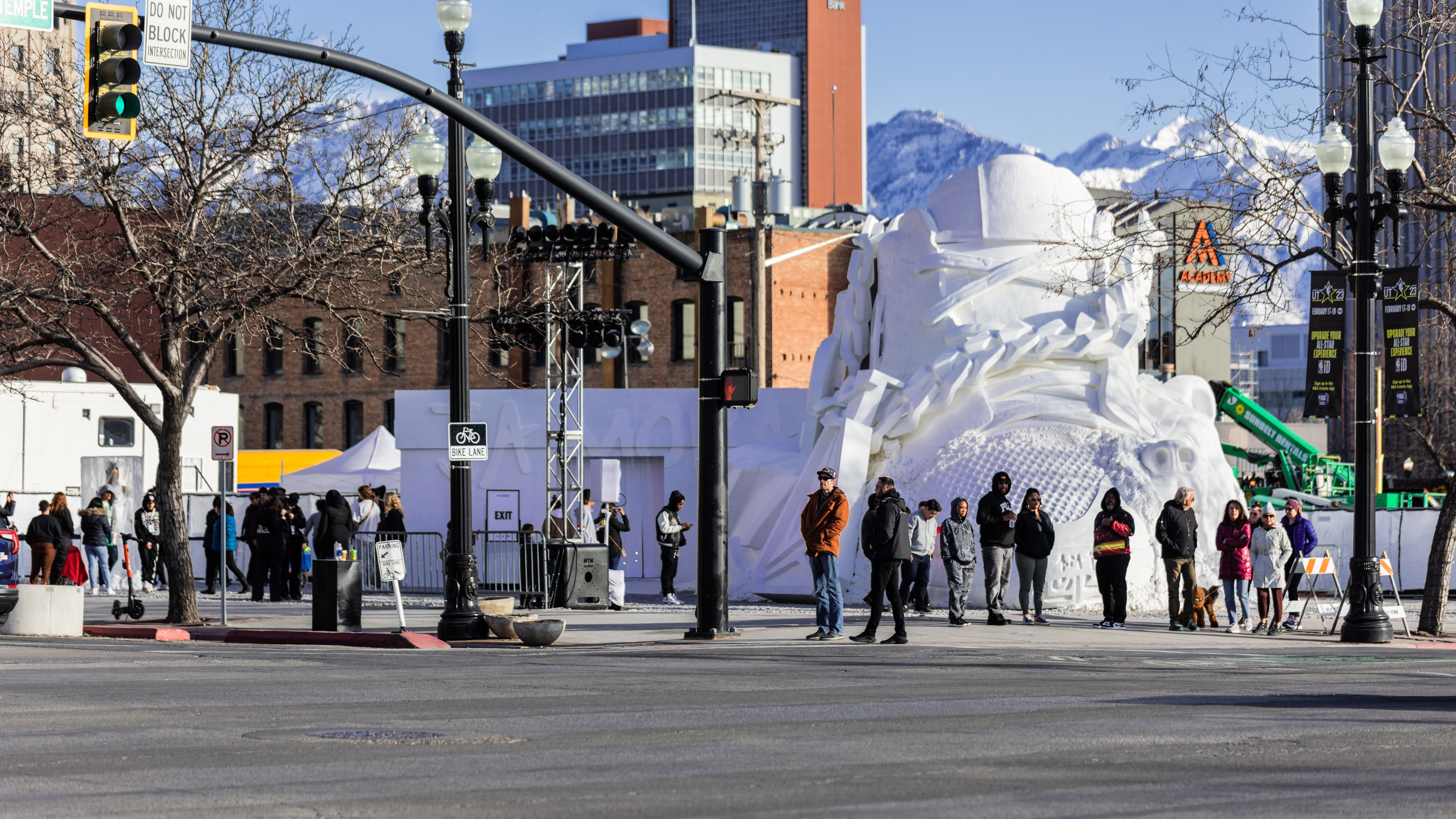 Busy street corner with huge Nike sneaker sculpture installation