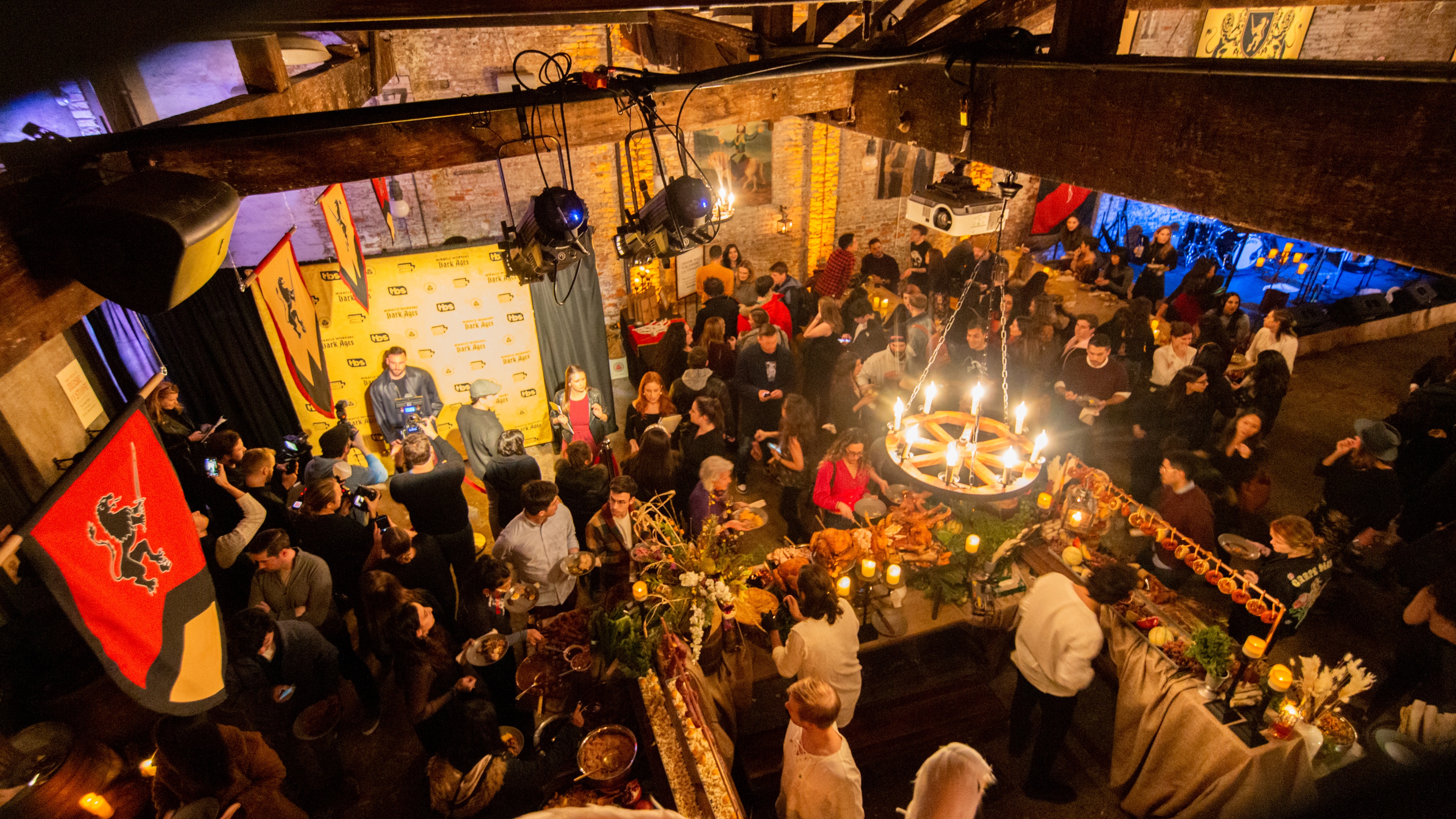 Aerial shot of warmly lit room with guest mingling