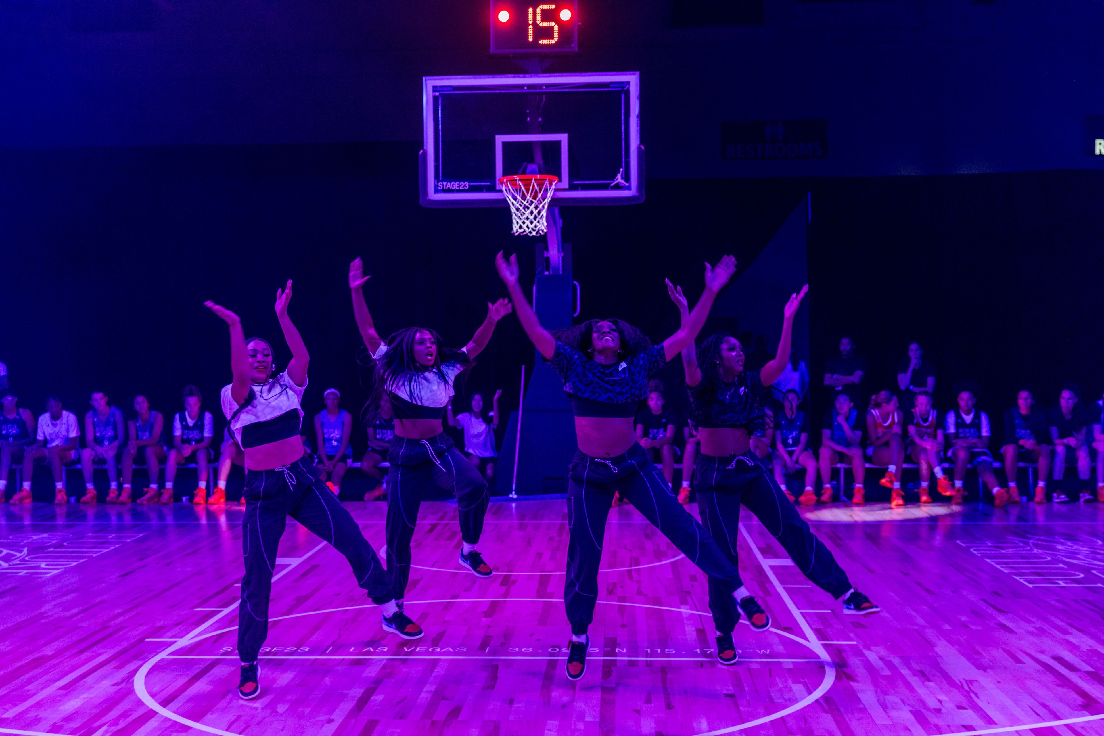 Nike Jordan Brand WNBA All-Star Weekend Las Vegas group of female cheerleaders performing in court, in jumping jack position