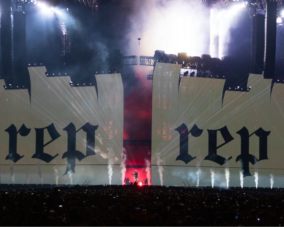 taylor swift performing, "rep" project on stage screens