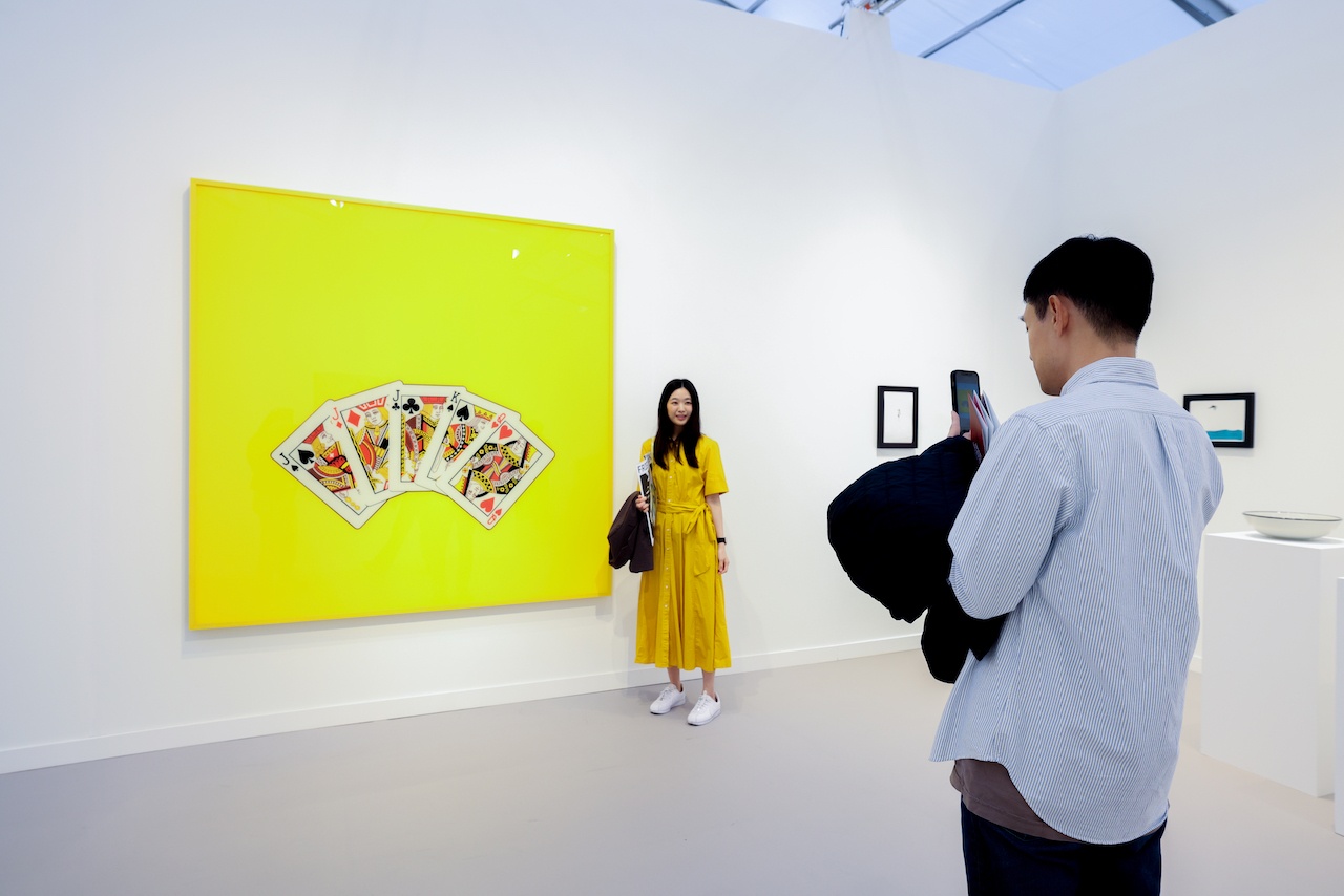 Woman posing in front of neon green art piece